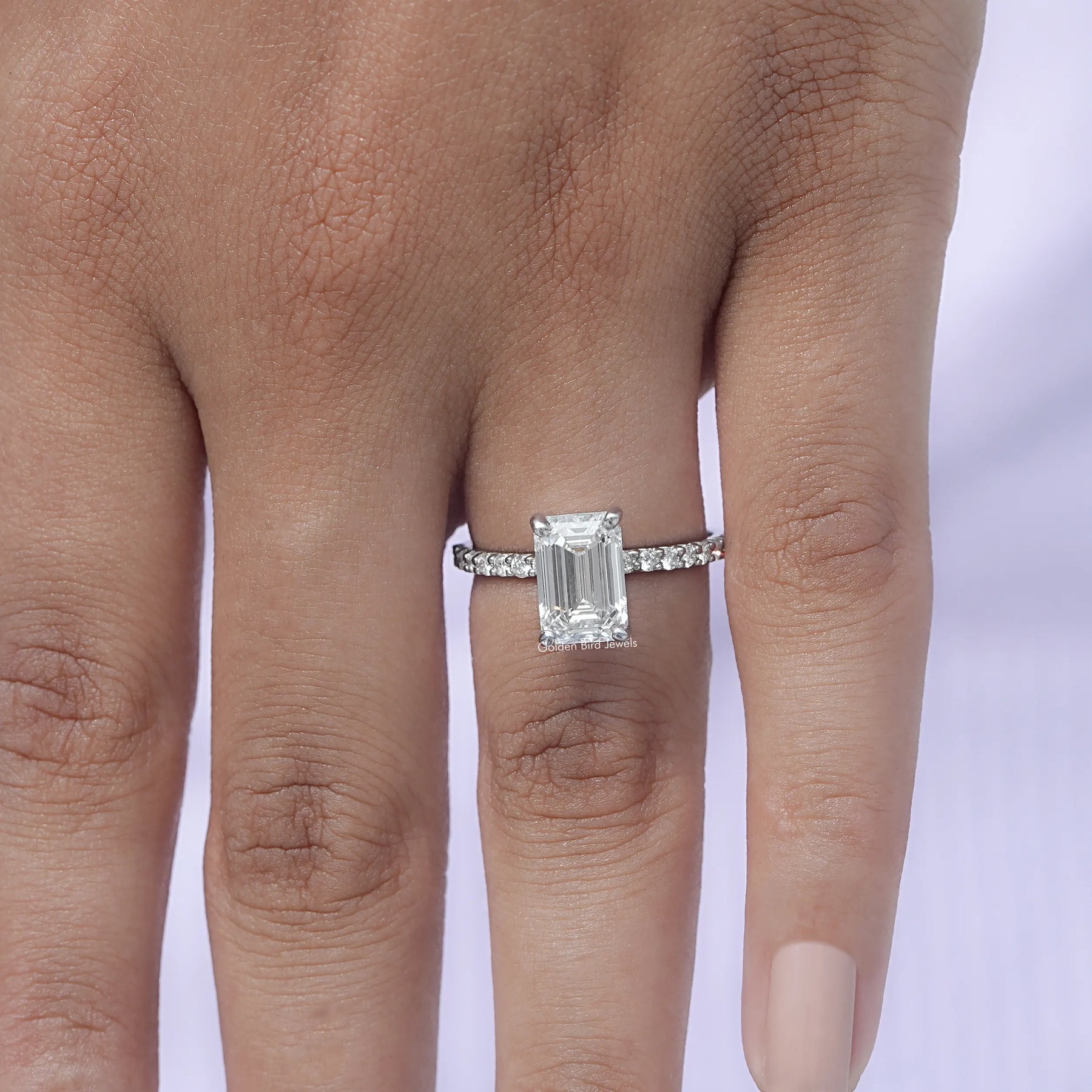 Close-Up View of Emerald Cut Diamond Engagement Ring In White Gold