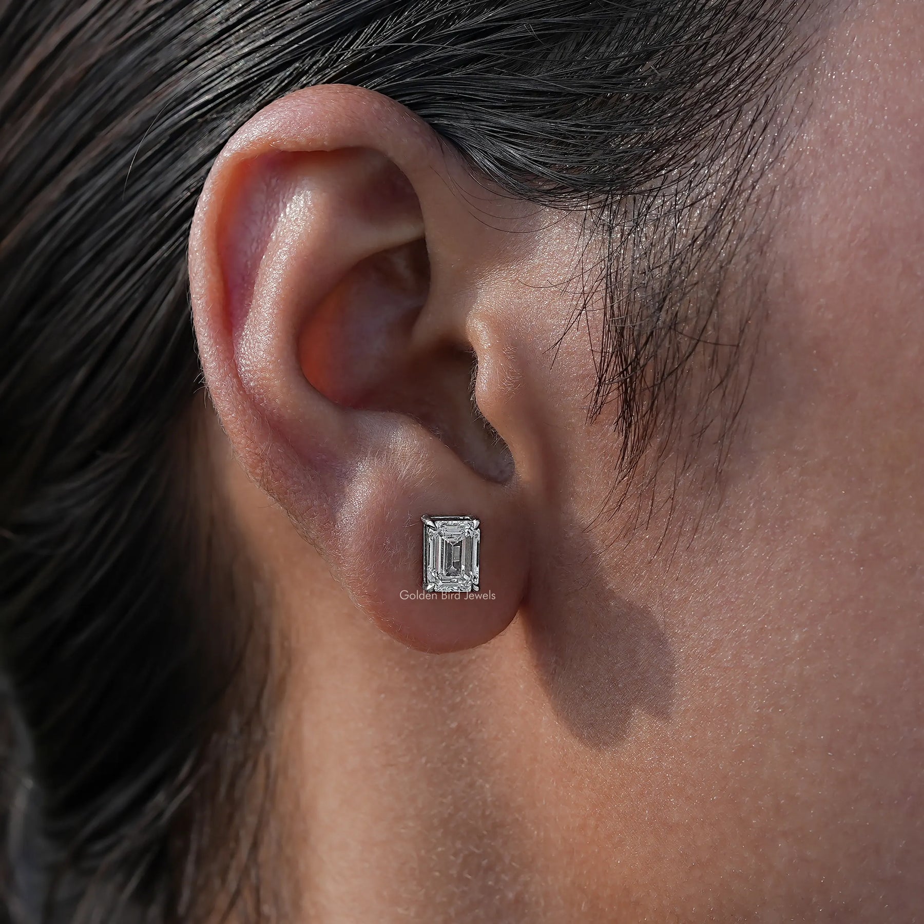 In ear view of Lab Diamond Emerald Cut Stud Earrings