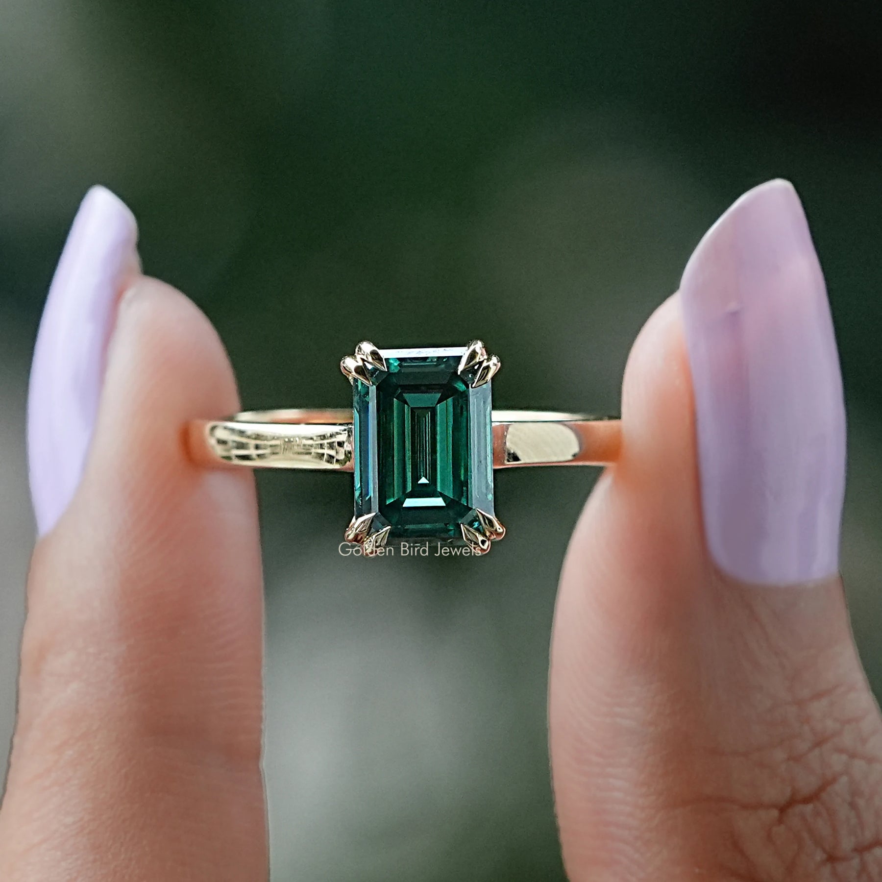 Front view of emerald shape moissanite engagement ring