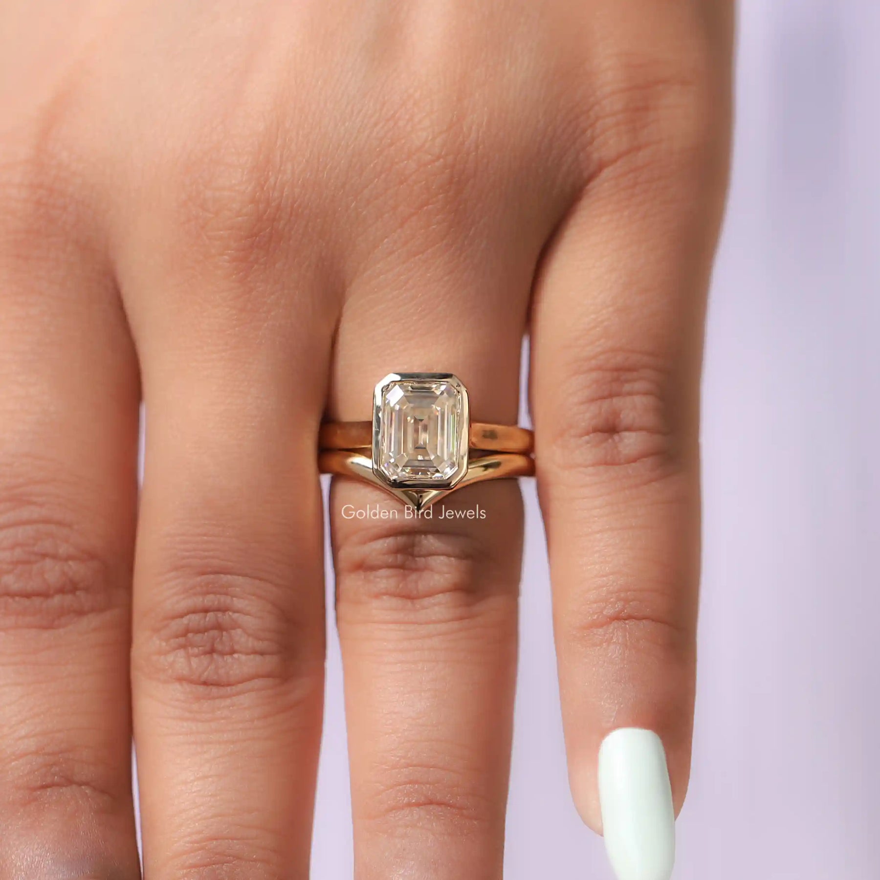 View of Emerald Cut Moissanite Solitaire Bezel Ring In Finger