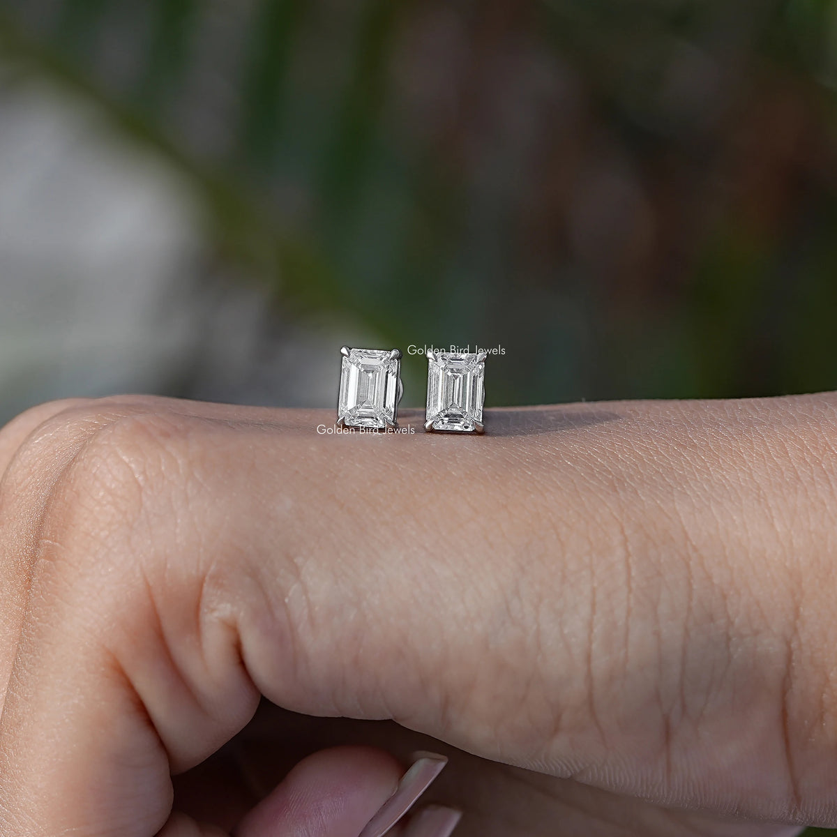 In Hand View Of emerald shaped diamond Stud Earring