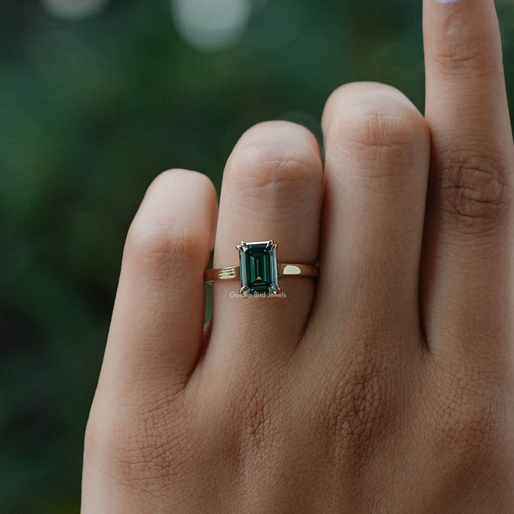 In Finger close view of moissanite ring in yellow gold
