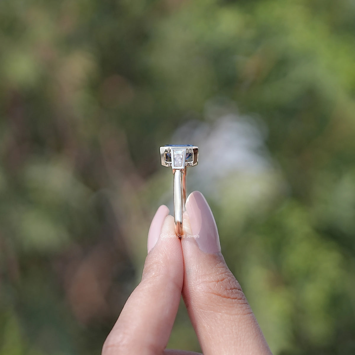 Side View of Blue Emerald Cut Moissanite Three Stone Ring