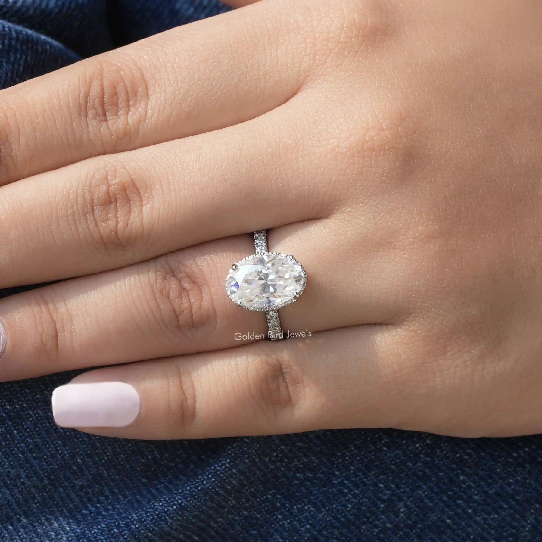 View of Oval Cut Halo Engagement Ring In White Gold