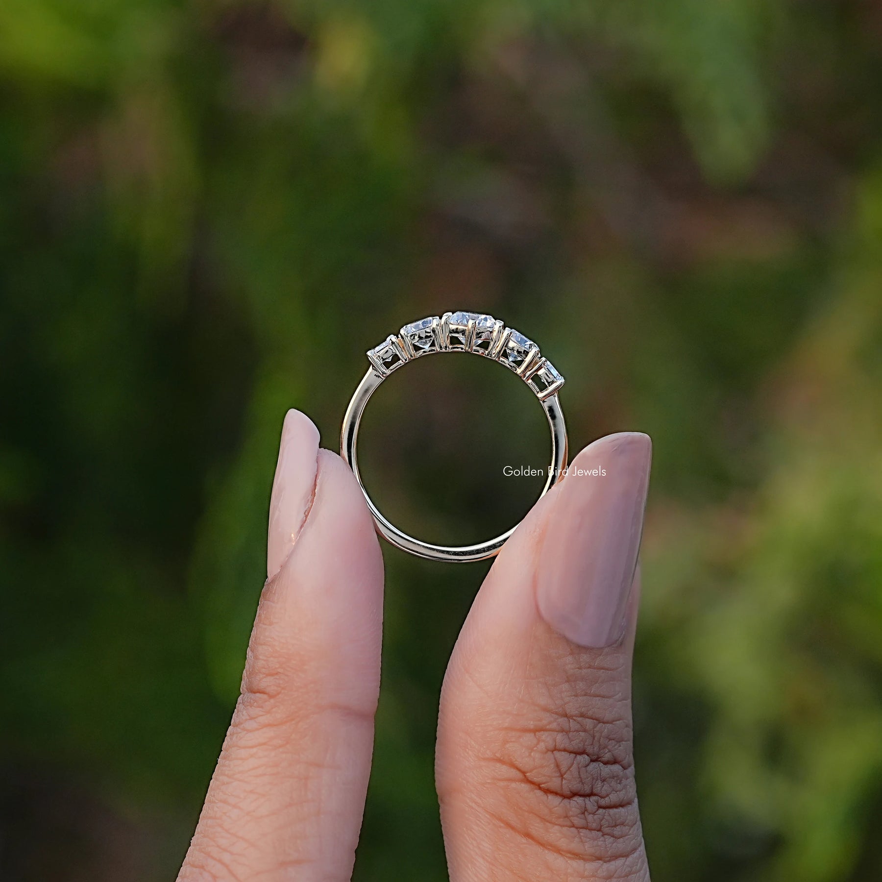Back View of Five Stone Octagon And Round Cut Diamond Ring In two fingers
