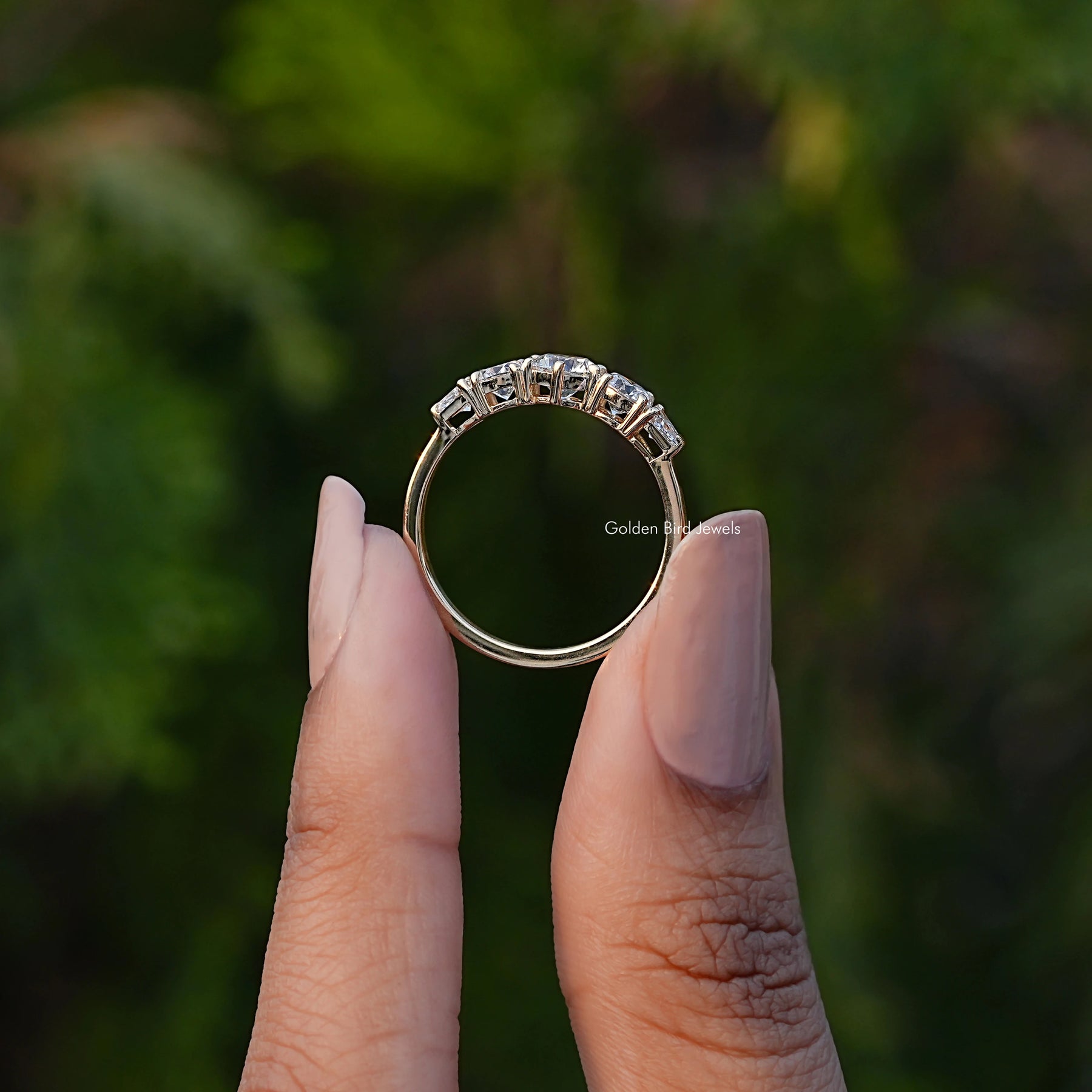 Back View of Round Cut Lab Diamond Five Stone Ring In two fingers