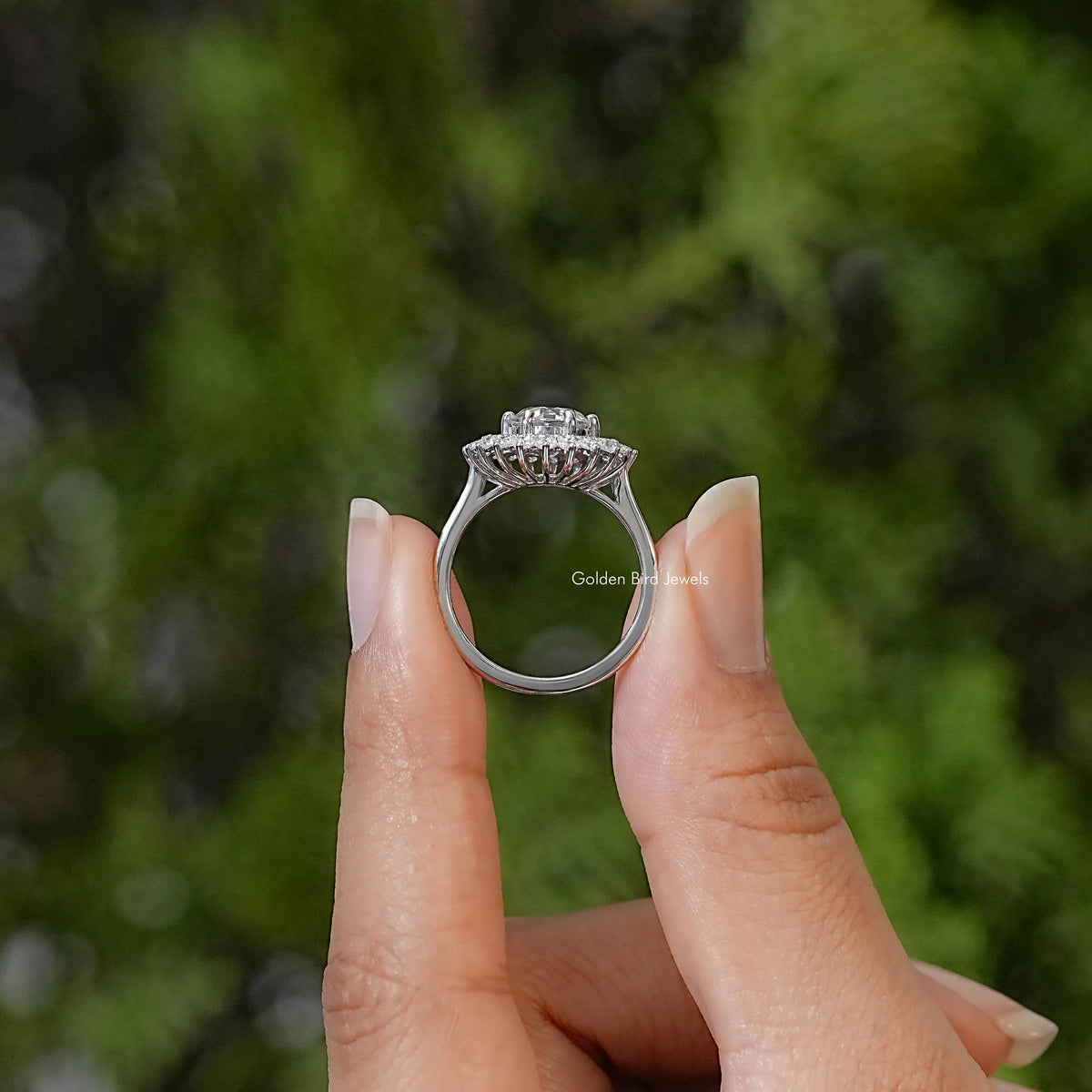 Sterling silver halo ring shown from the side, with a raised setting and open gallery.