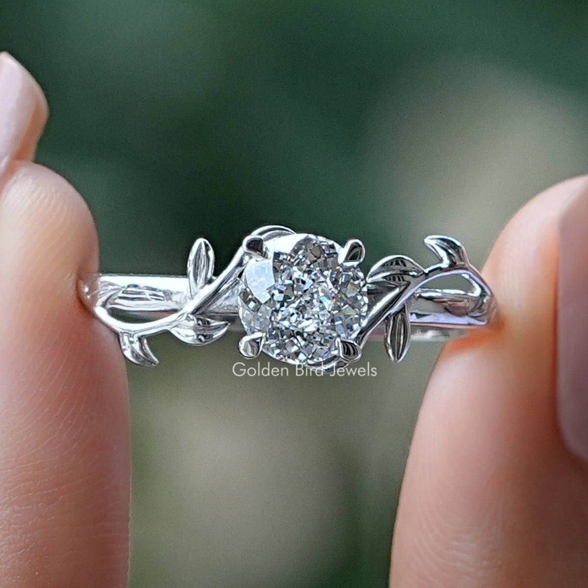 Portuguese Cut Round Diamond Engagement Ring Held Between Fingers