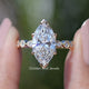 Marquise Cut Lab Diamond Accent Bridal Ring Set Held Between Fingers