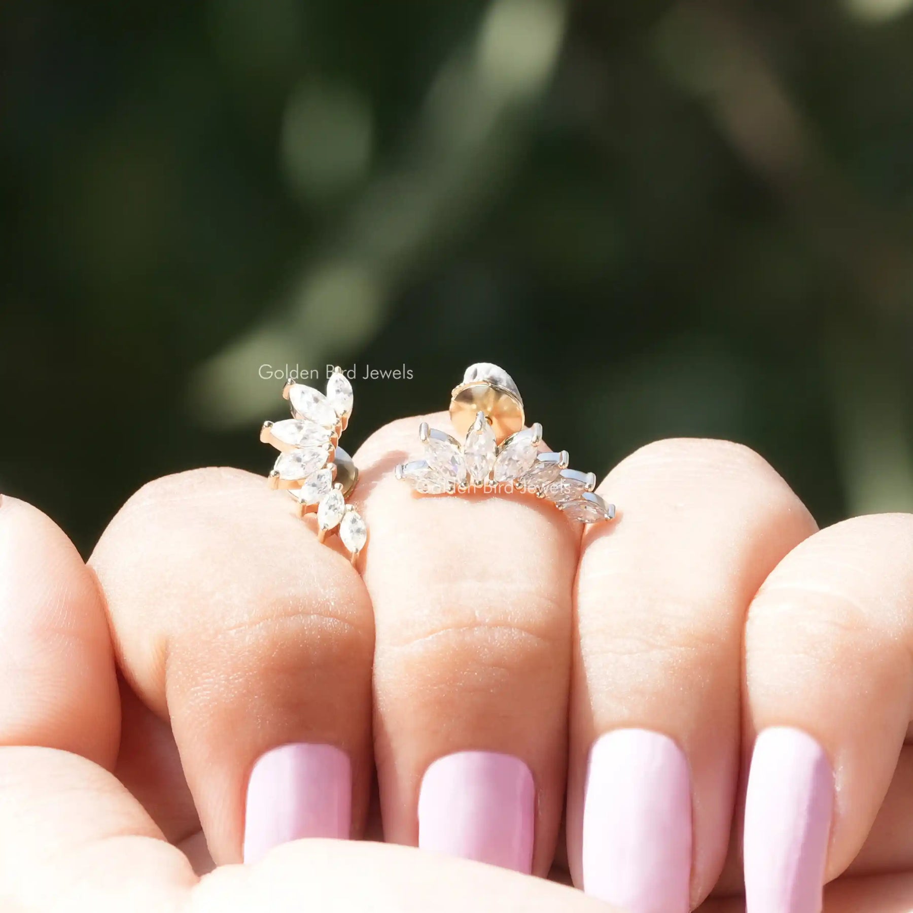 Front view of marquise cut moissanite stud earrings in yellow gold