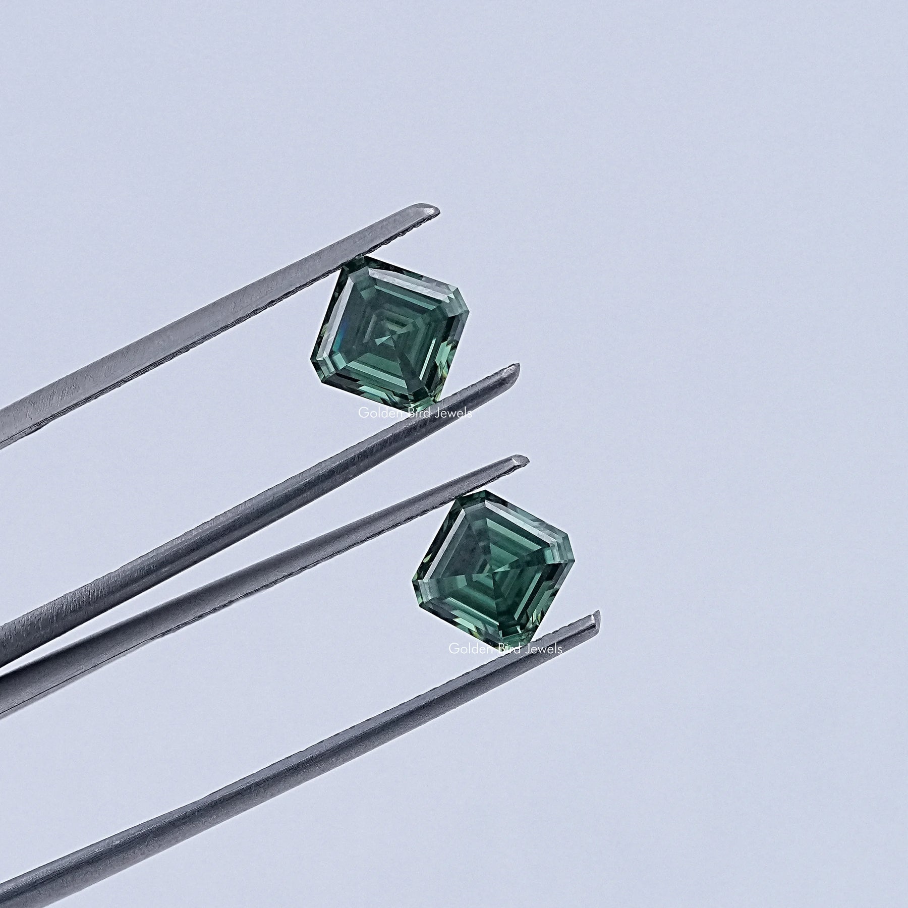 In Tweezer View Of Green Asscher Cut Moissanite Loose Pair