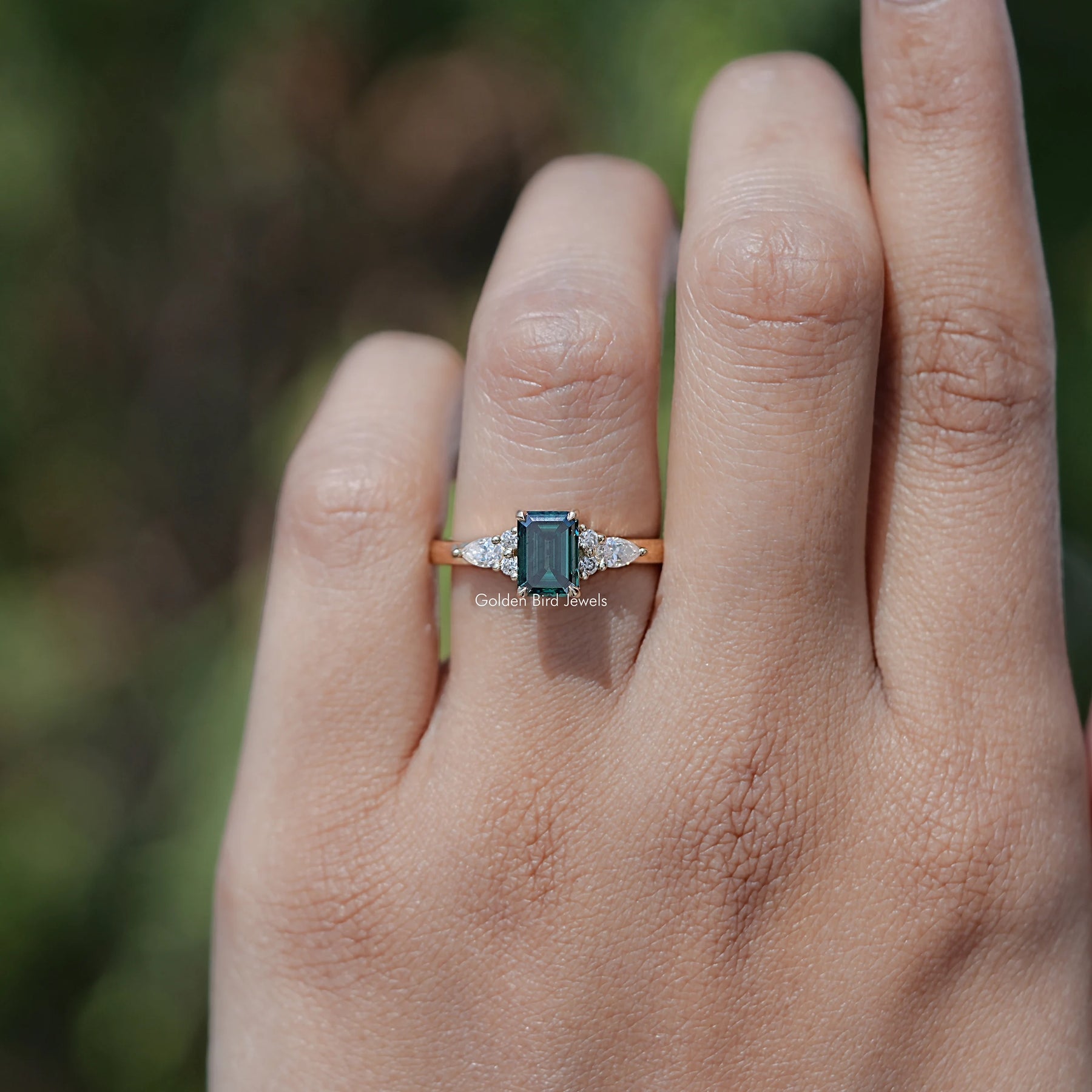 Top View Of Green Emerald Moissanite Engagement Ring in prongs setting