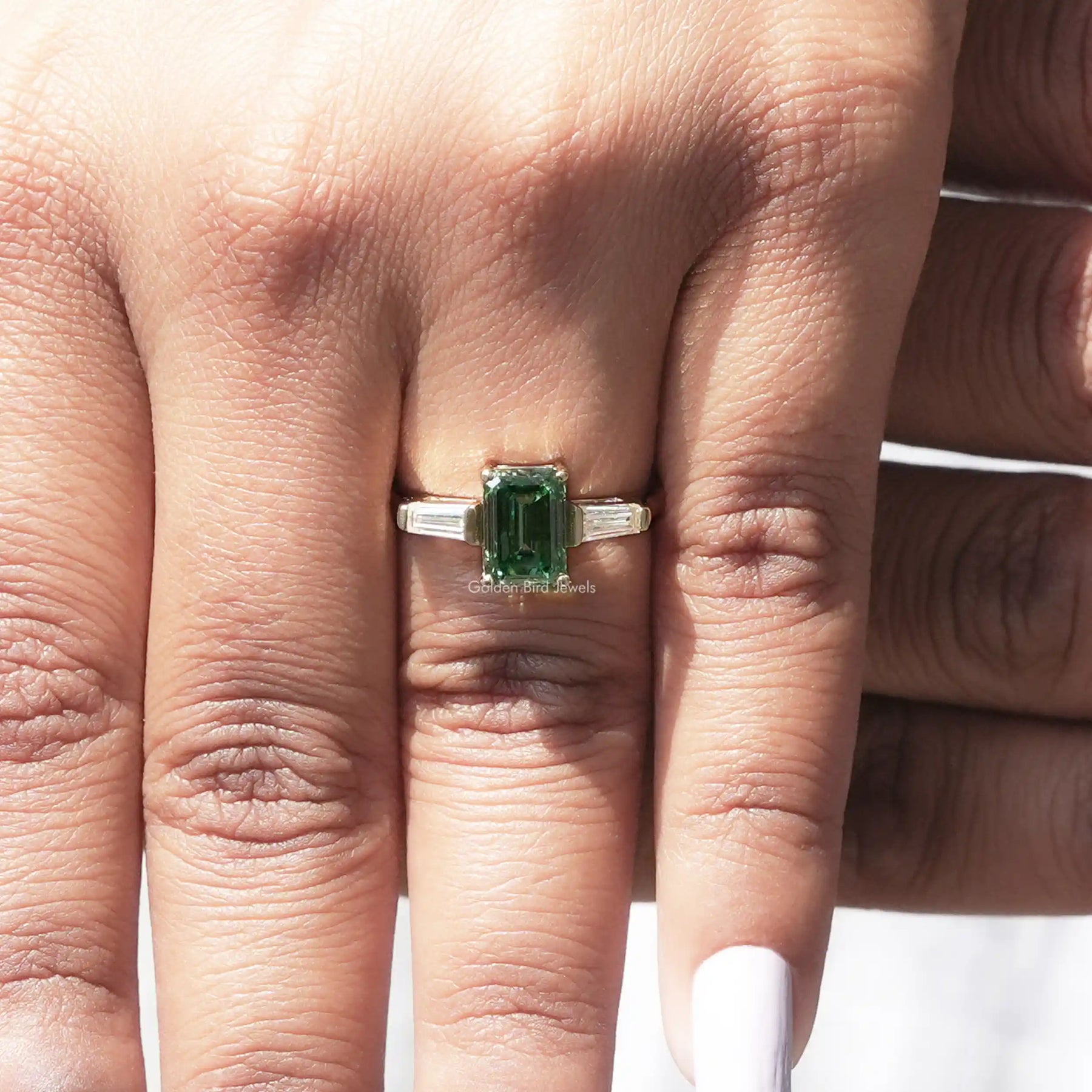 View of Emerald And Baguette Cut Engagement Ring In Yellow Gold