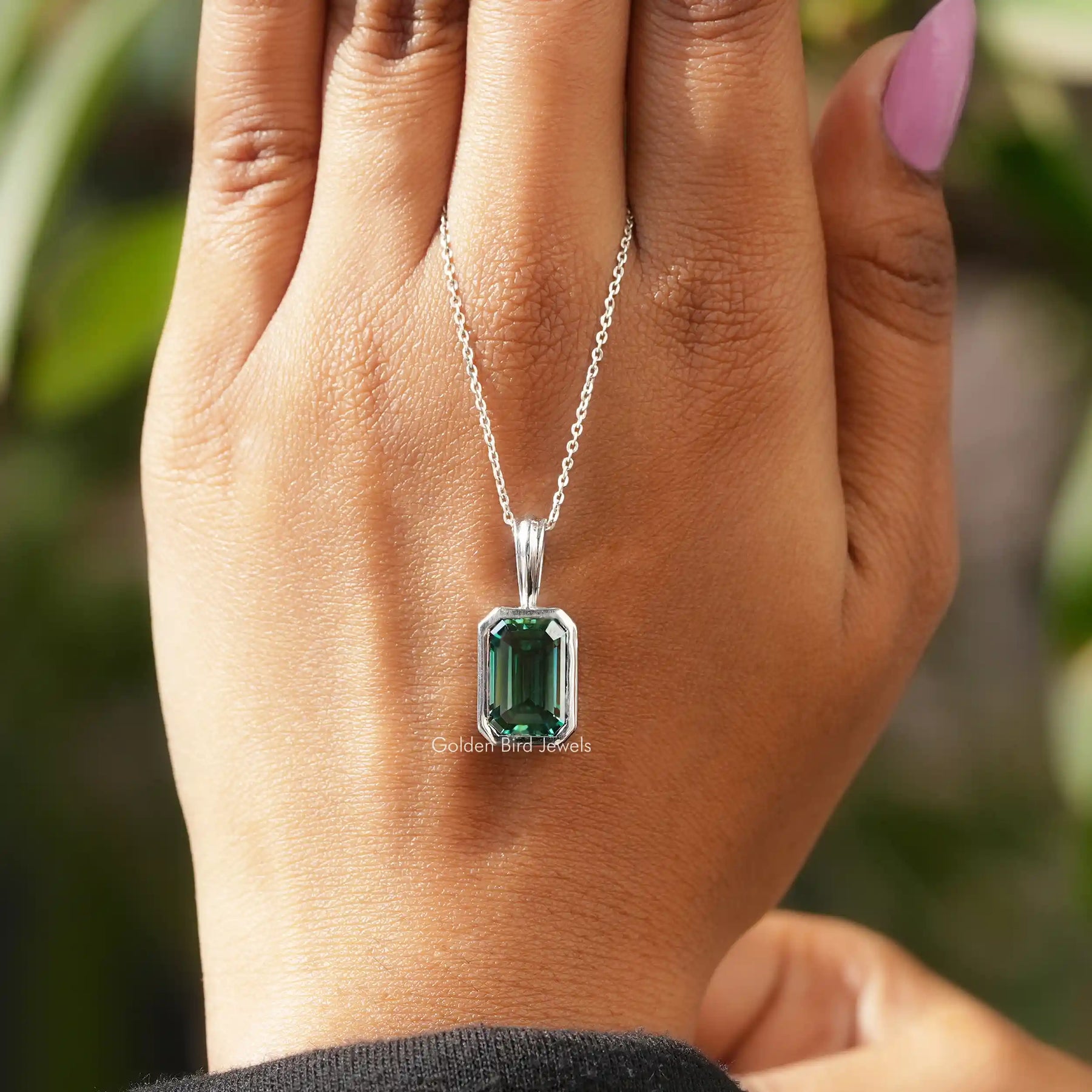 Detailed view of moissanite emerald shape pendant