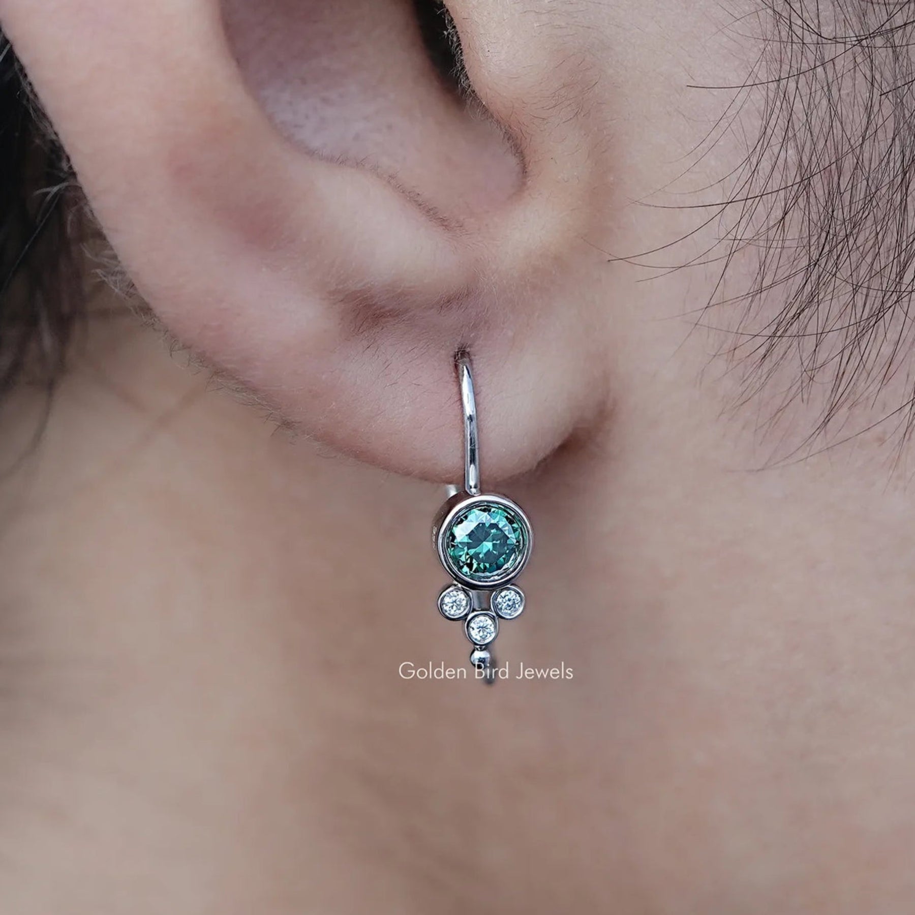 In Ear View Of Green Round Moissanite Earwire Drop Earrings in prongs setting