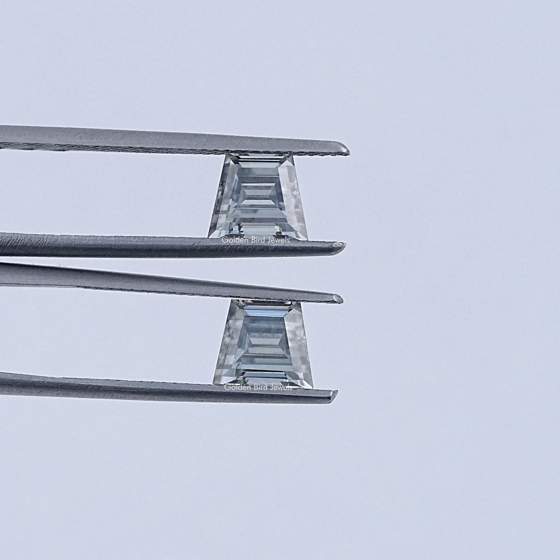 In Tweezer View Of Grey Trapezoid Cut Moissanite Loose Pair