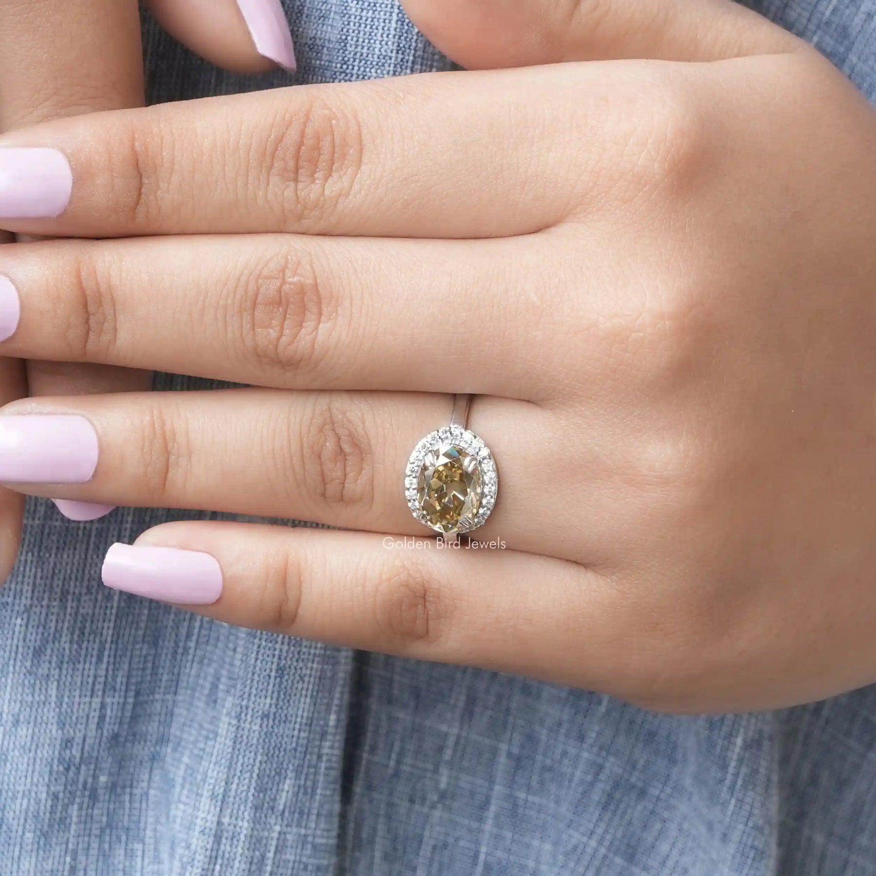 View of Brown Oval Cut Halo Style Moissanite Ring In finger