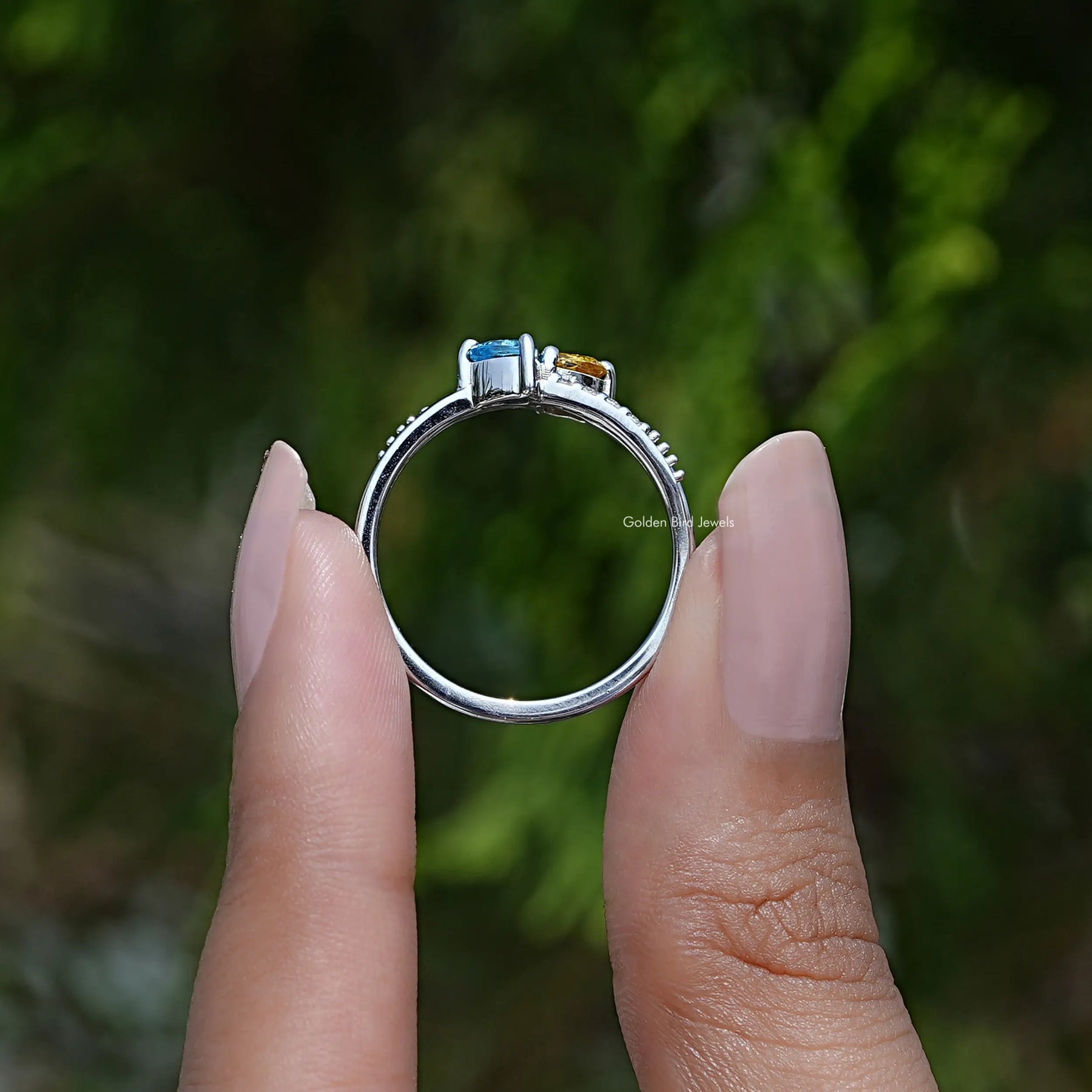 Back View of Heart Shaped Toi Moi Engagement Ring In two fingers