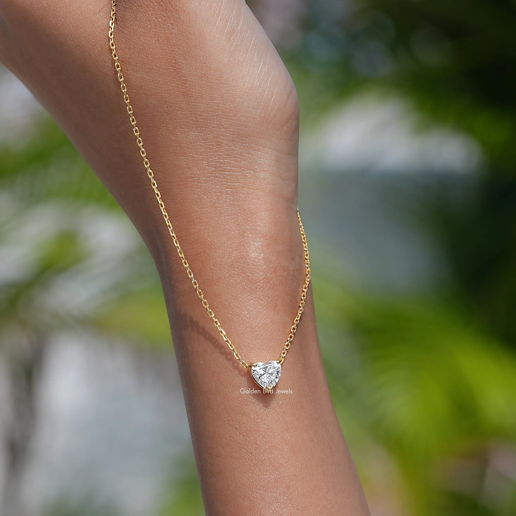 In hand showing view of diamond pendant