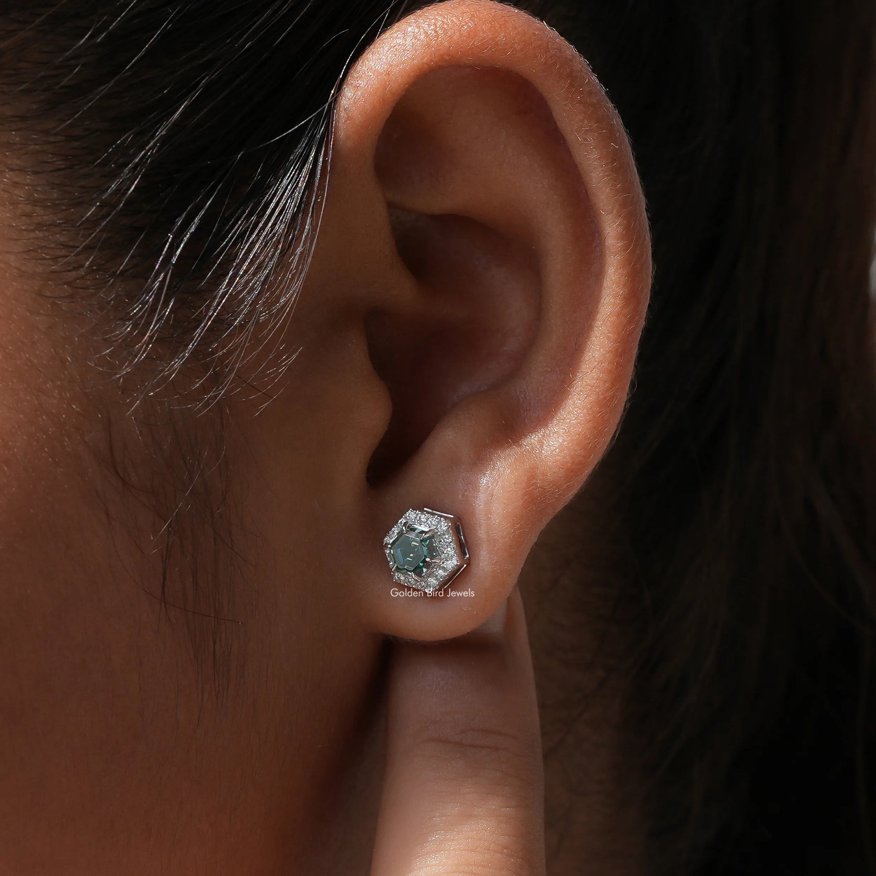 Side ear view of stud earrings Crafted in green moissanite