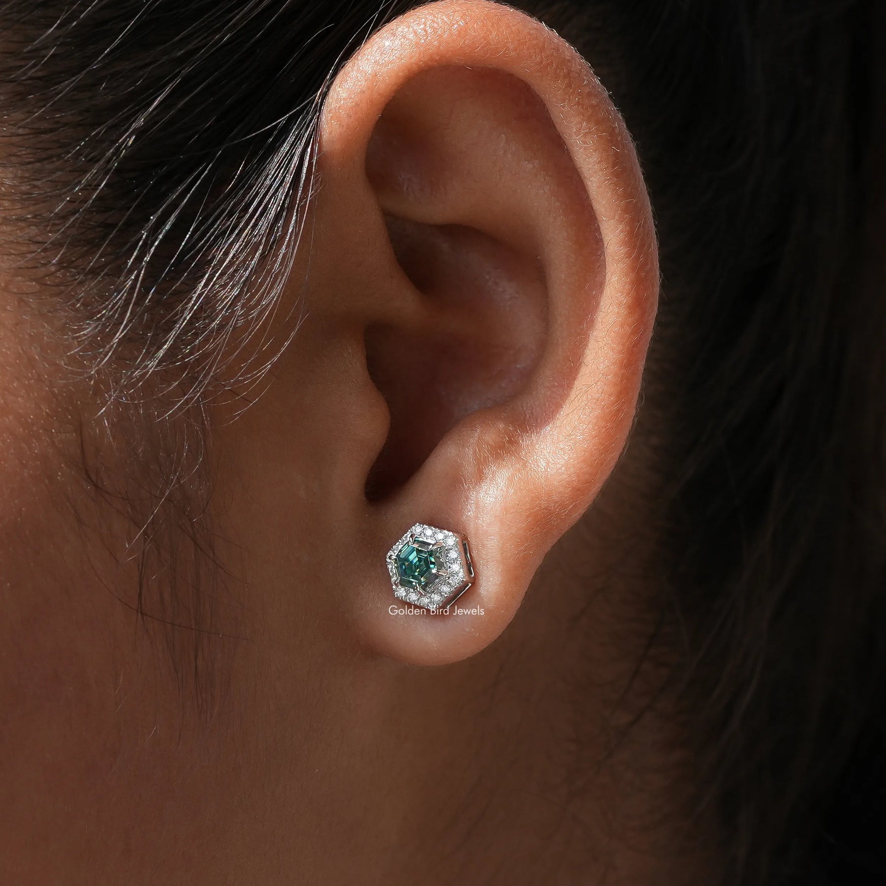 View of green moissanite stud earrings for women