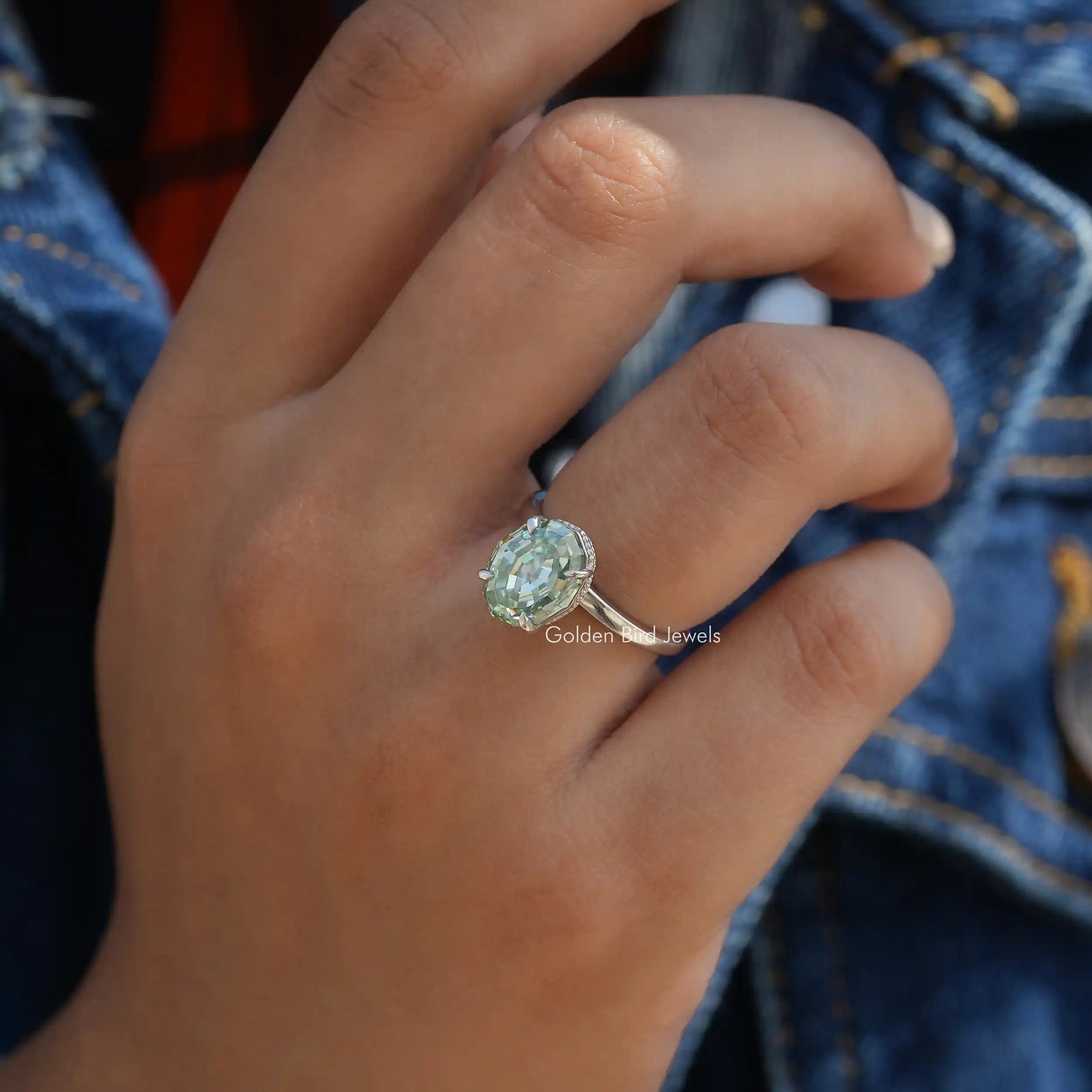 View of Step Cut Oval Hidden Halo Ring In Finger