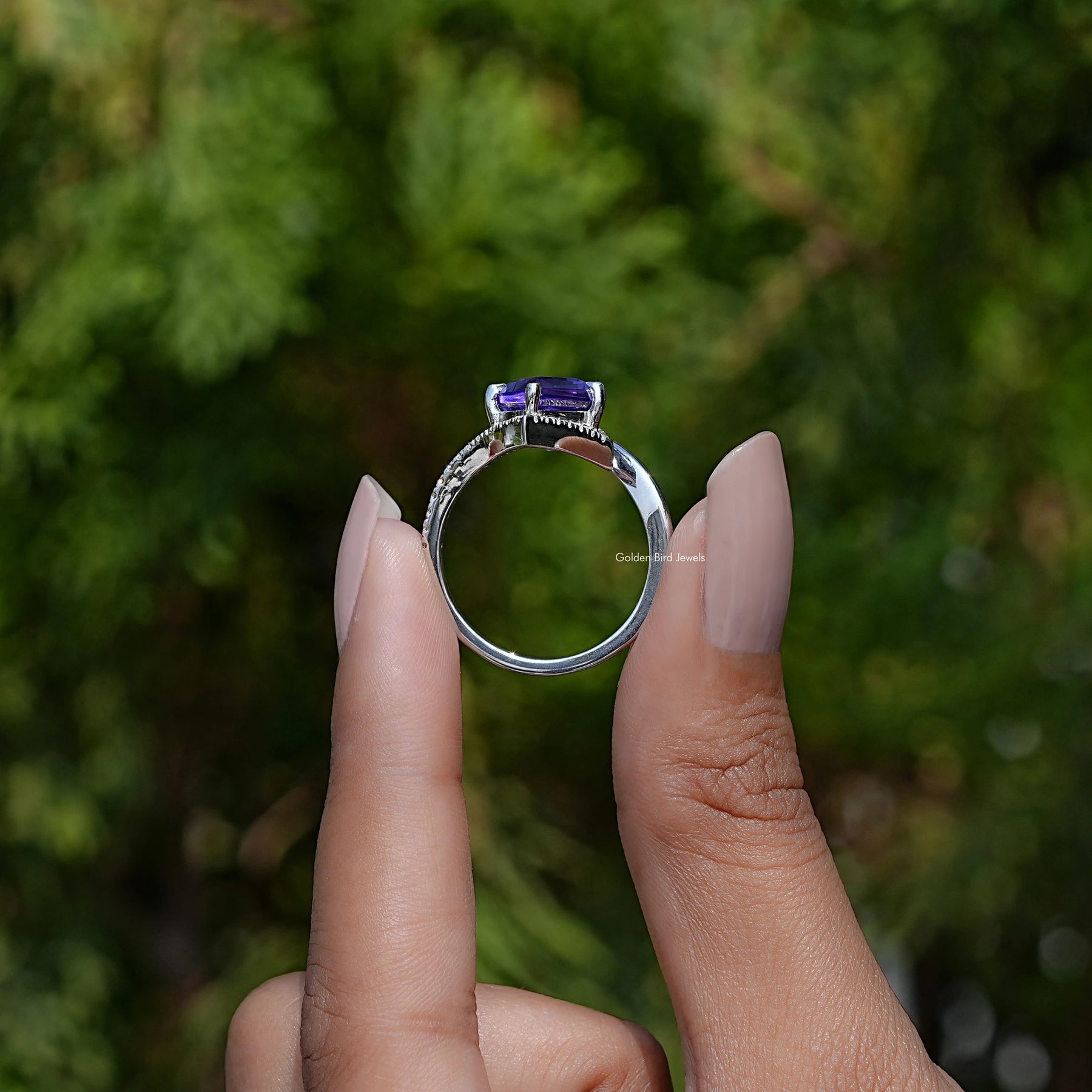Back View of Kite Cut Gemstone Halo Accent Ring In two fingers