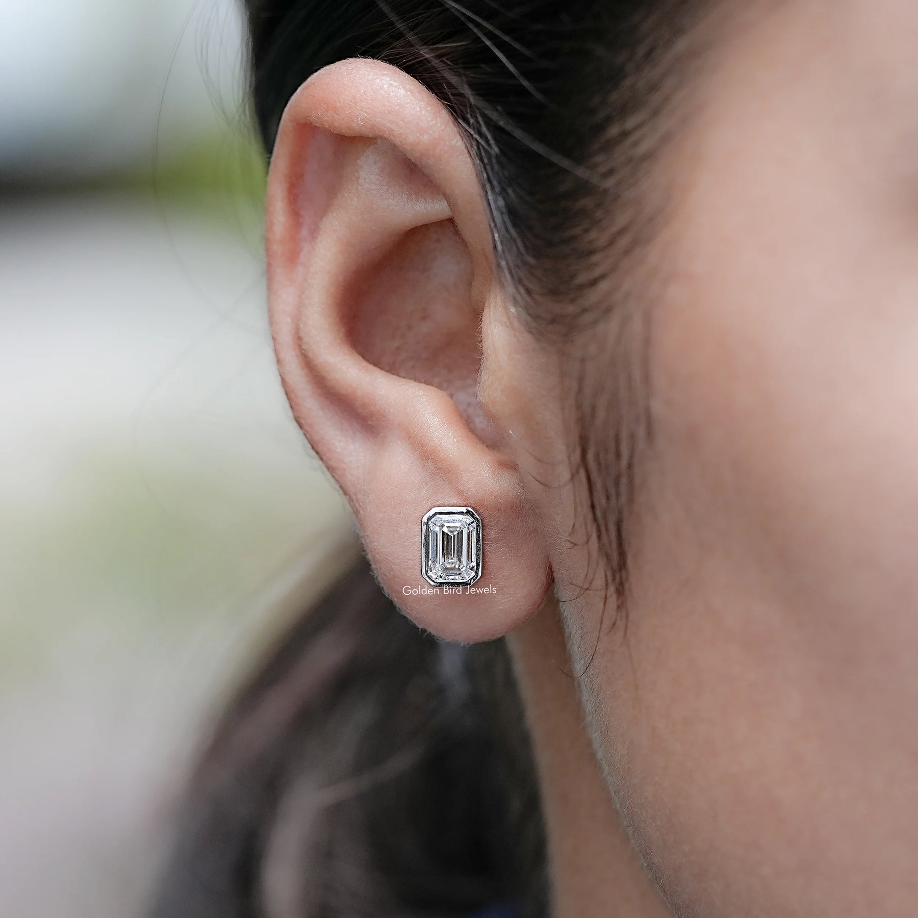 In Ear View of Emerald Cut Lab Diamond Bezel Set Stud Earrings