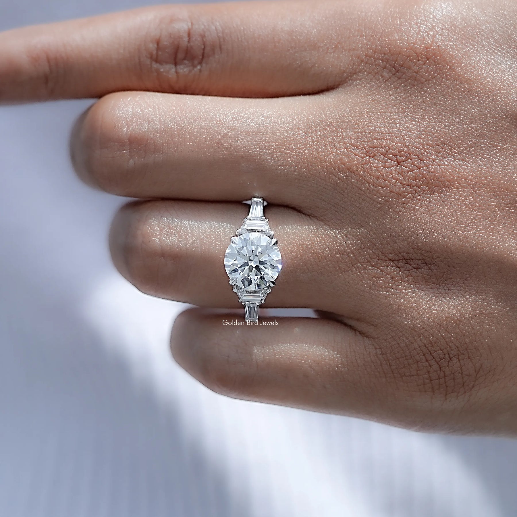 Detailed view of Round And Step Cut Trapezoid Diamond Ring