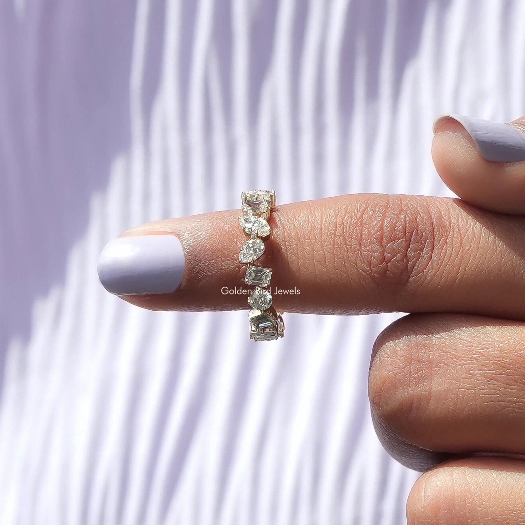 In finger front View of Marquise Cut Lab Diamond Eternity Wedding Band In Yellow Gold