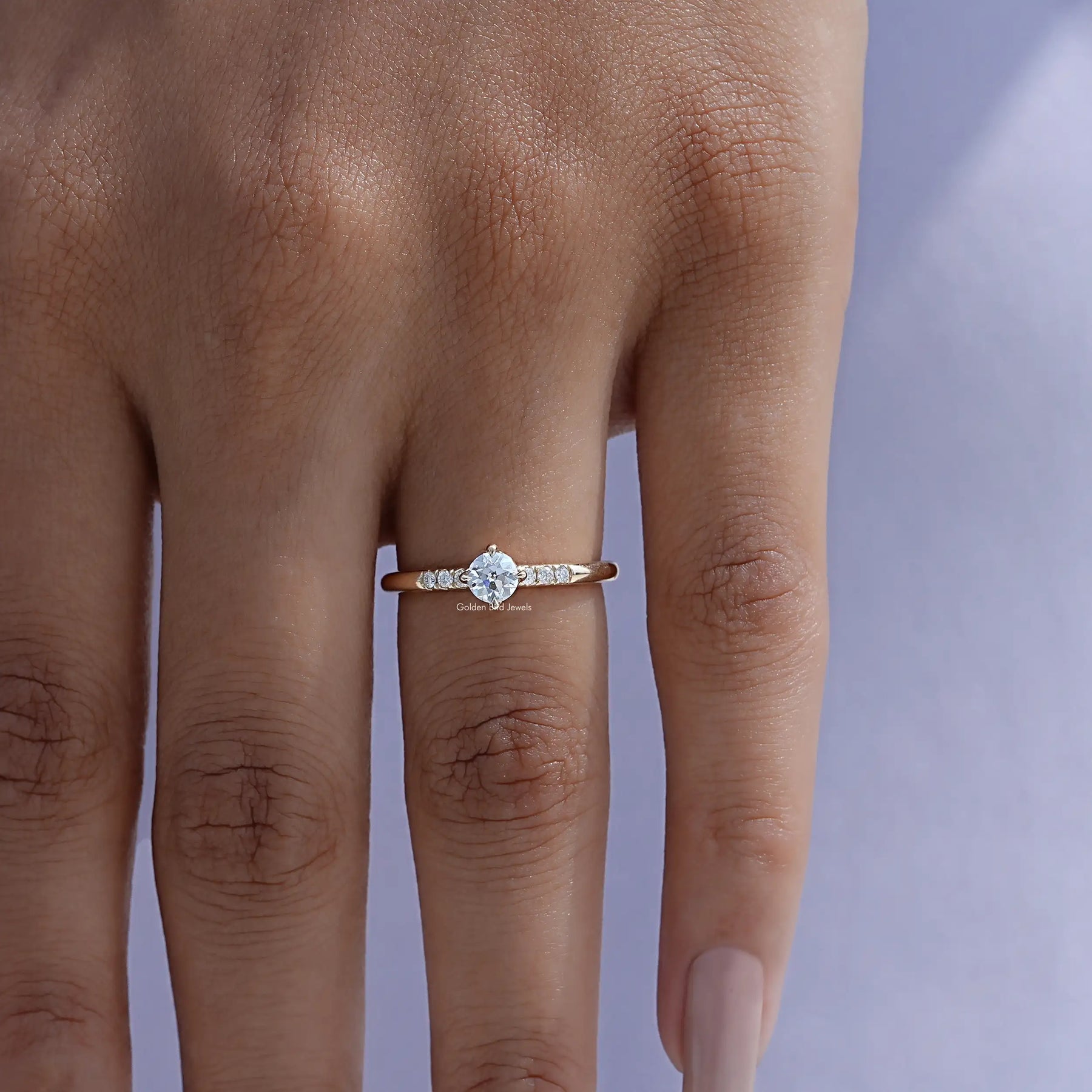 Detailed View of A Round Cut Lab Diamond Accent Ring In yellow gold