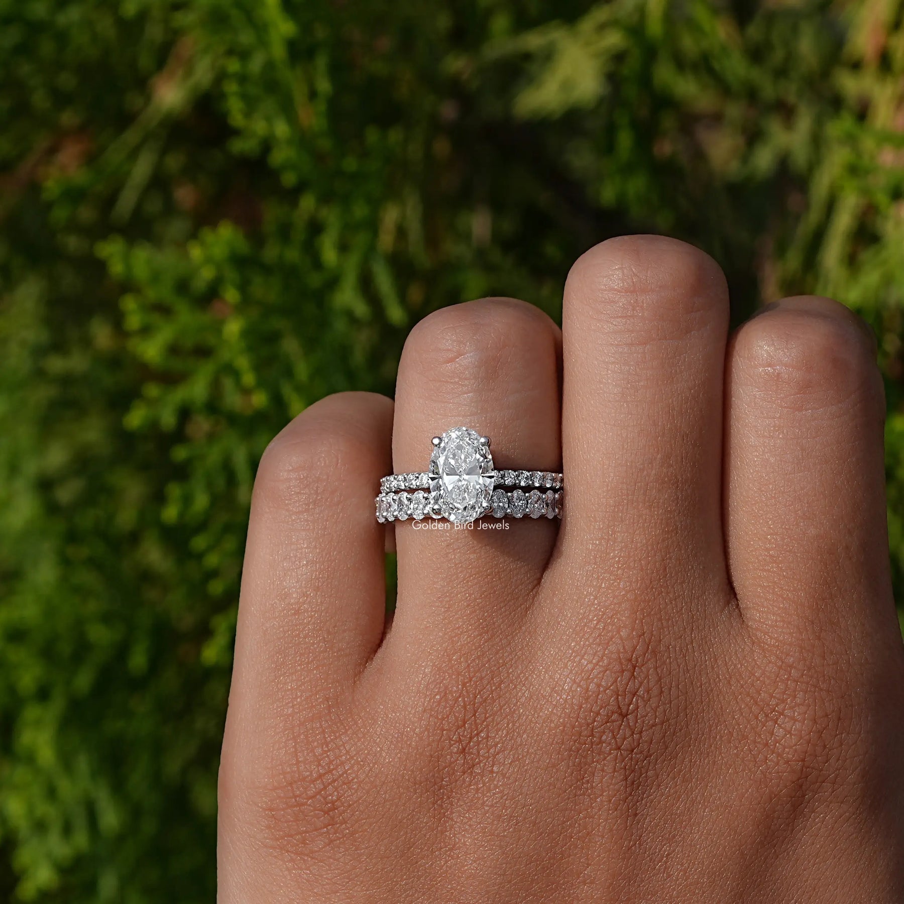 Oval Cut Lab Diamond Bridal Ring Set on a finger, front view