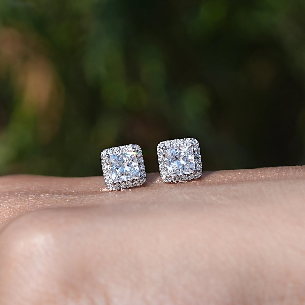 In Hand Showing View Of princess cut diamond stud Earring In White Gold