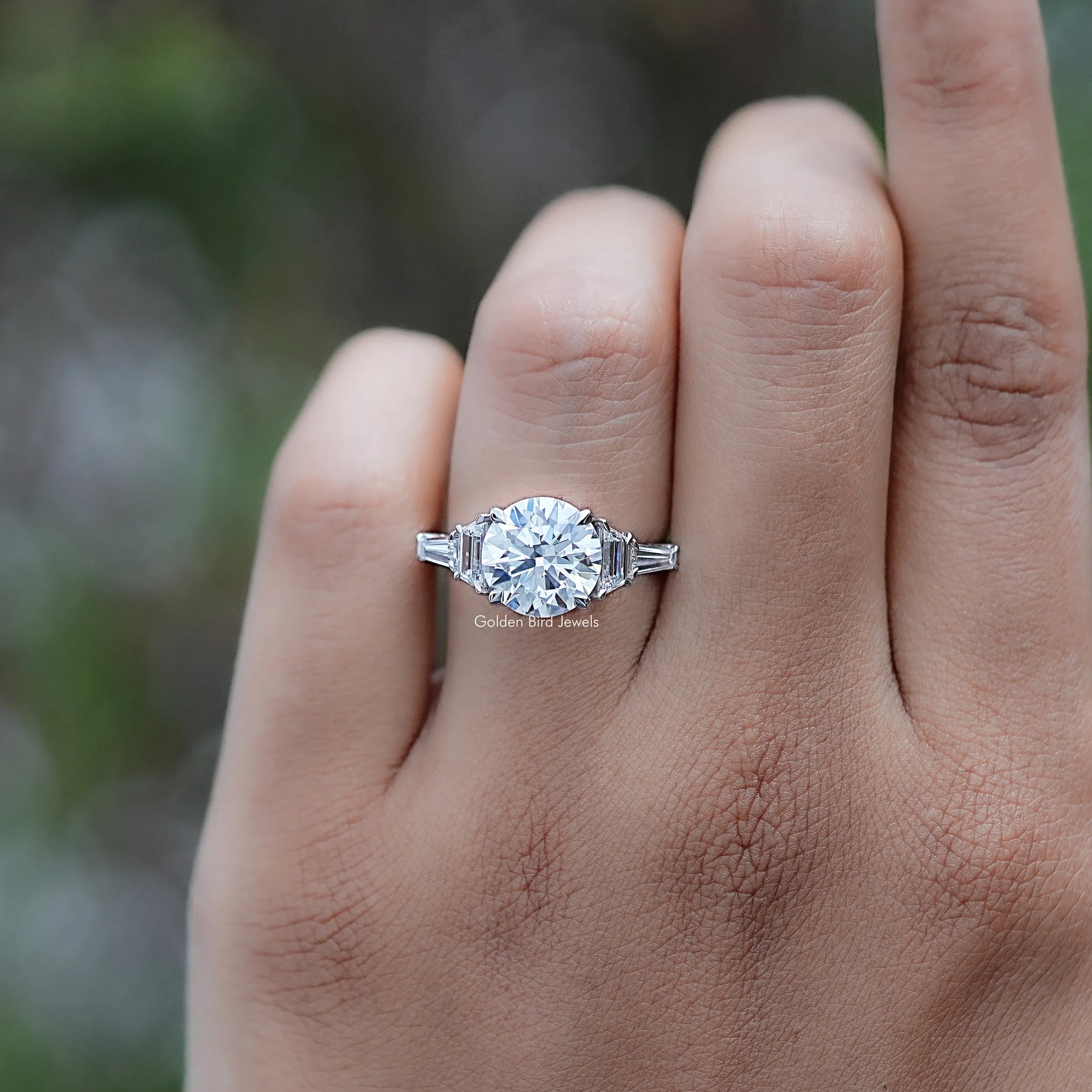 Front view of Round And Step Cut Trapezoid Diamond Ring