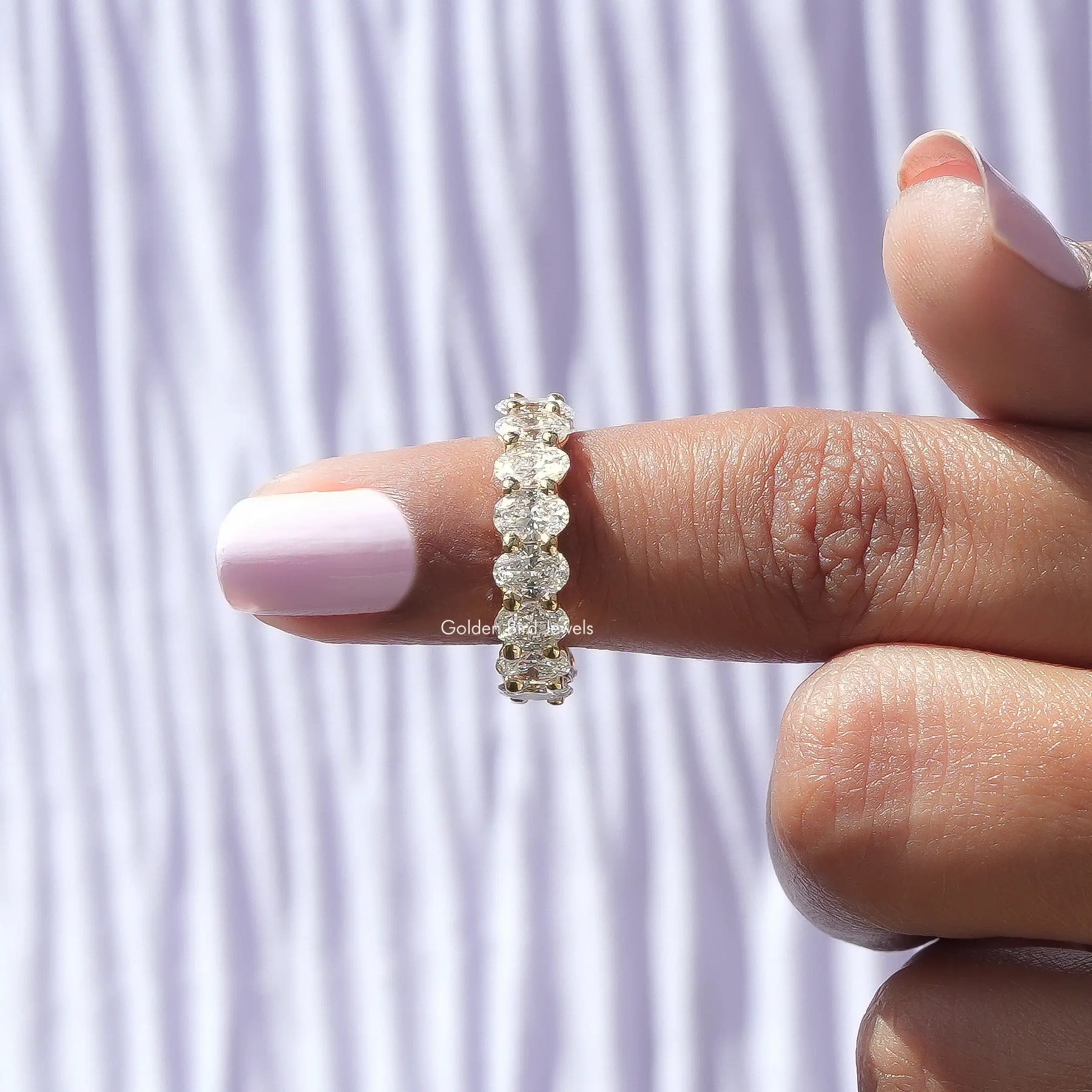 In finger front View of Oval Cut Diamond Eternity Band In White Gold