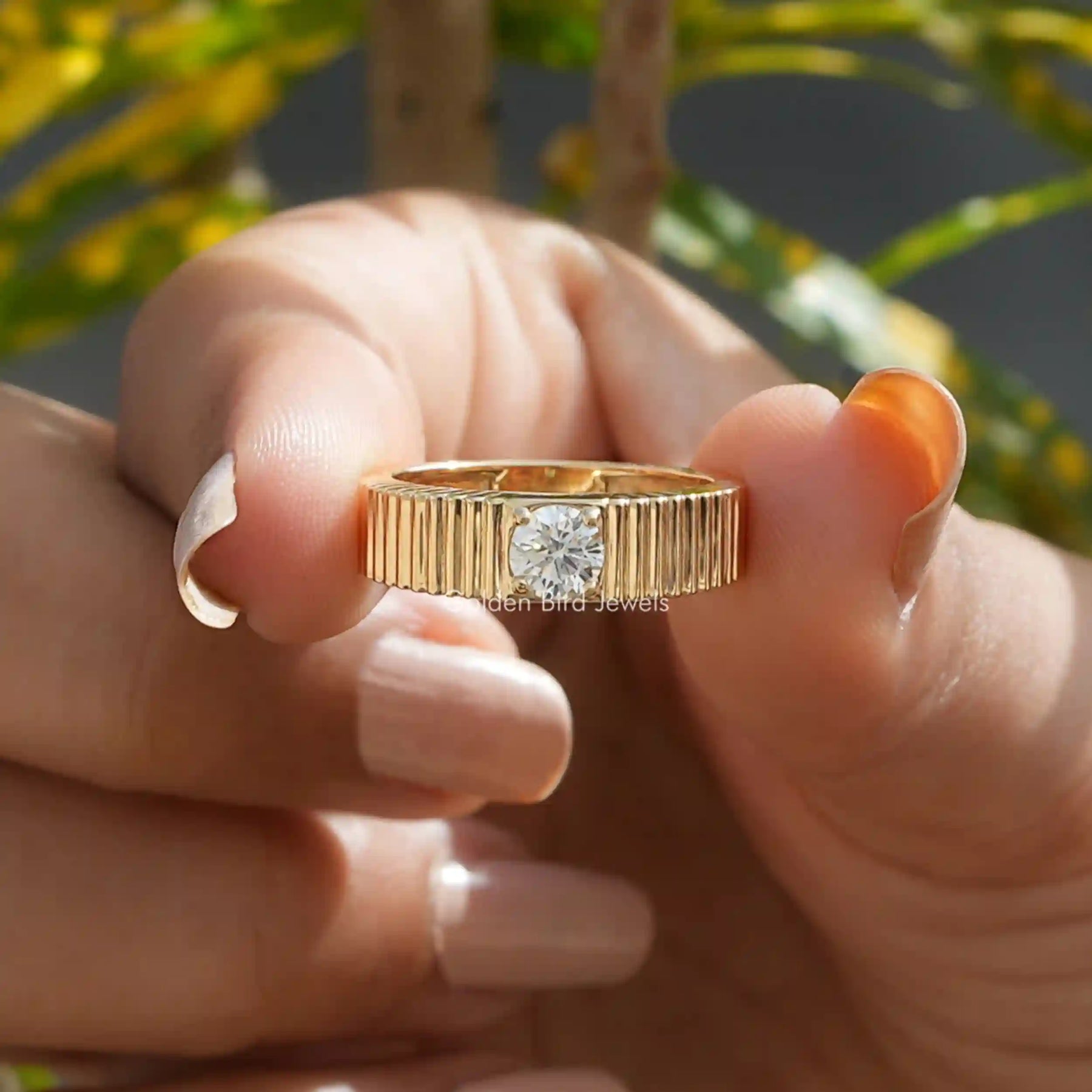 Front View of Round Cut Solitaire Engagement Ring In two Fingers