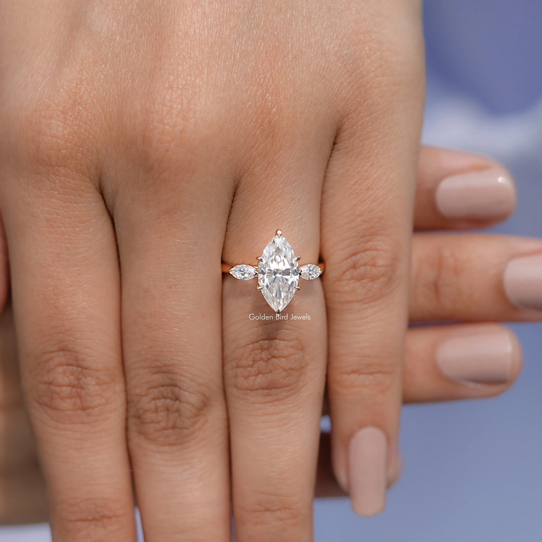In finger front view of Marquise Cut Moissanite Three Stone Ring in unique shape