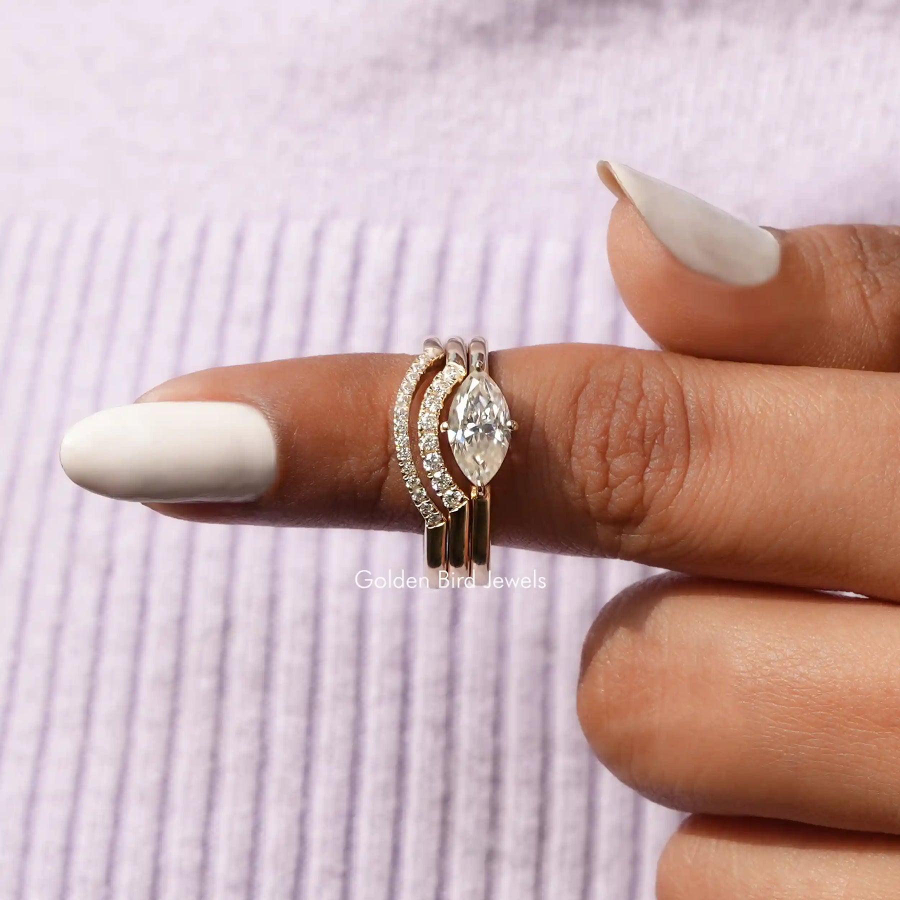In finger front view of Marquise Cut Bridal Curved Band Set In Yellow Gold