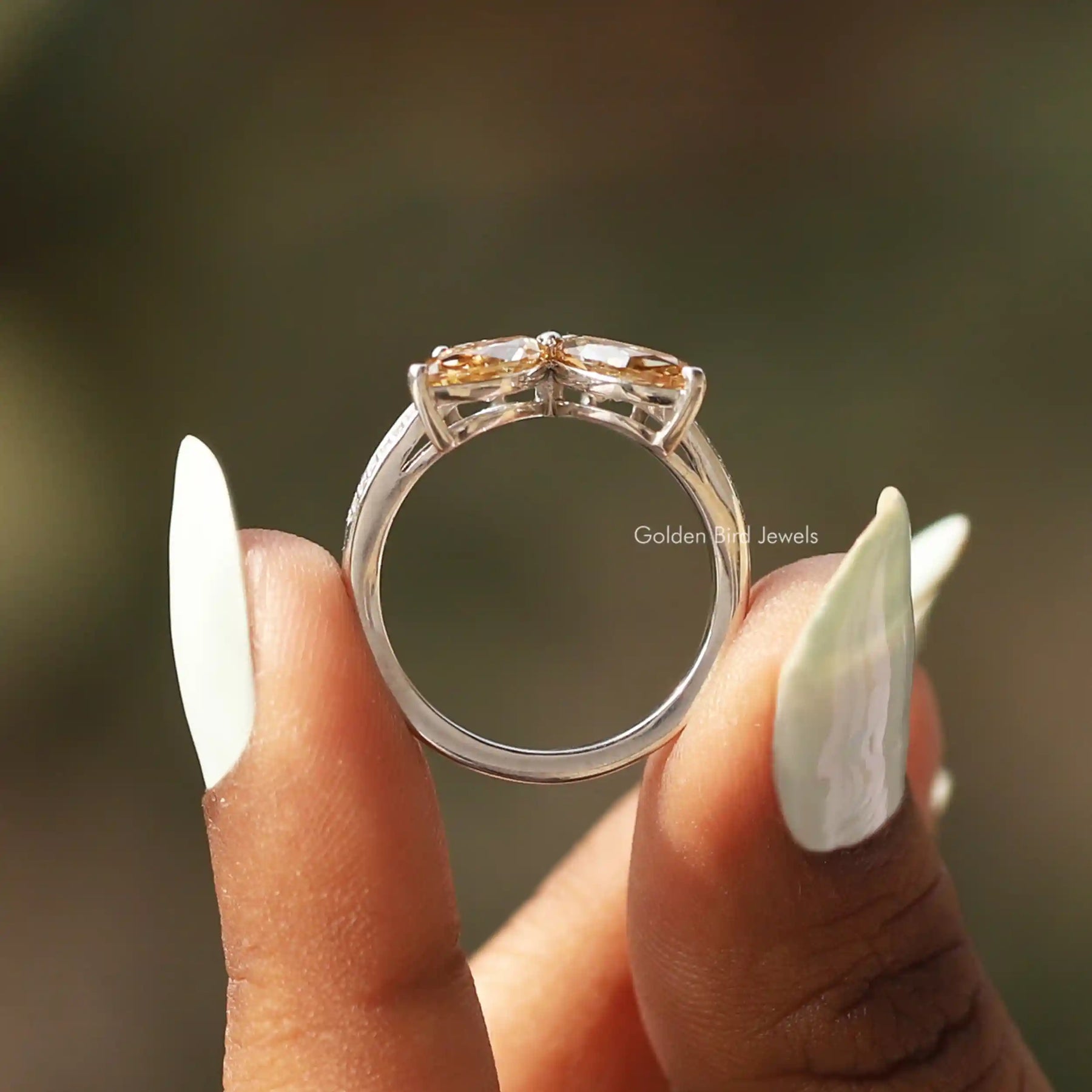 Back View of Marquise Cut Moissanite Engagement Ring In two fingers