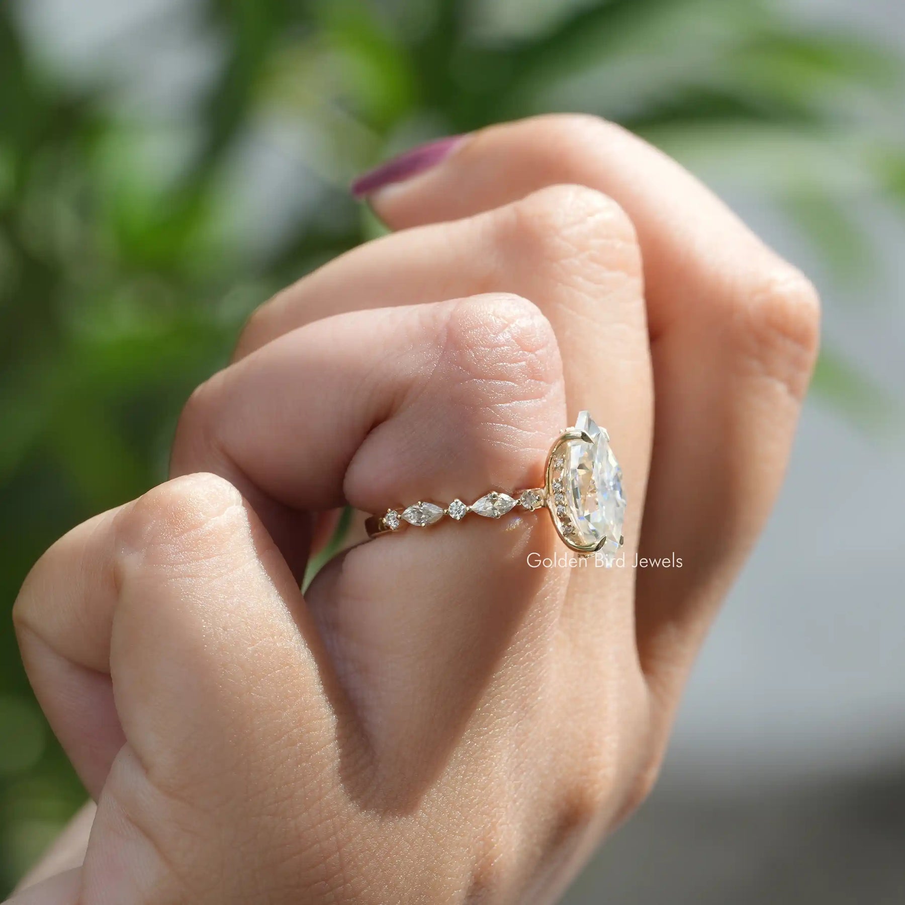 Side view of Dutch Marquise Moissanite Engagement Ring on folded finger