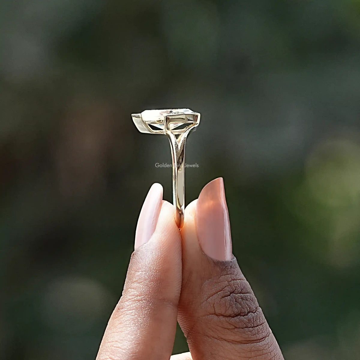 Side View of Moissanite Marquise Cut Solitaire Ring In two fingers