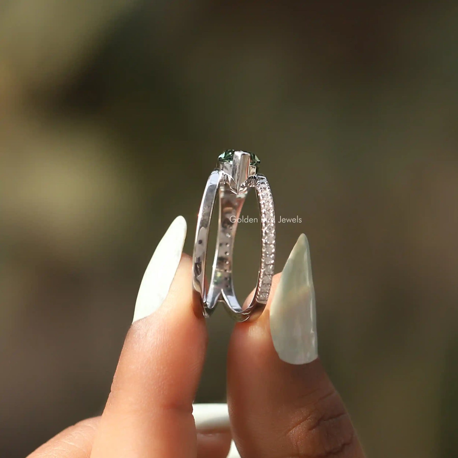 Side View of Marquise And Round Cut Moissanite Ring In two fingers