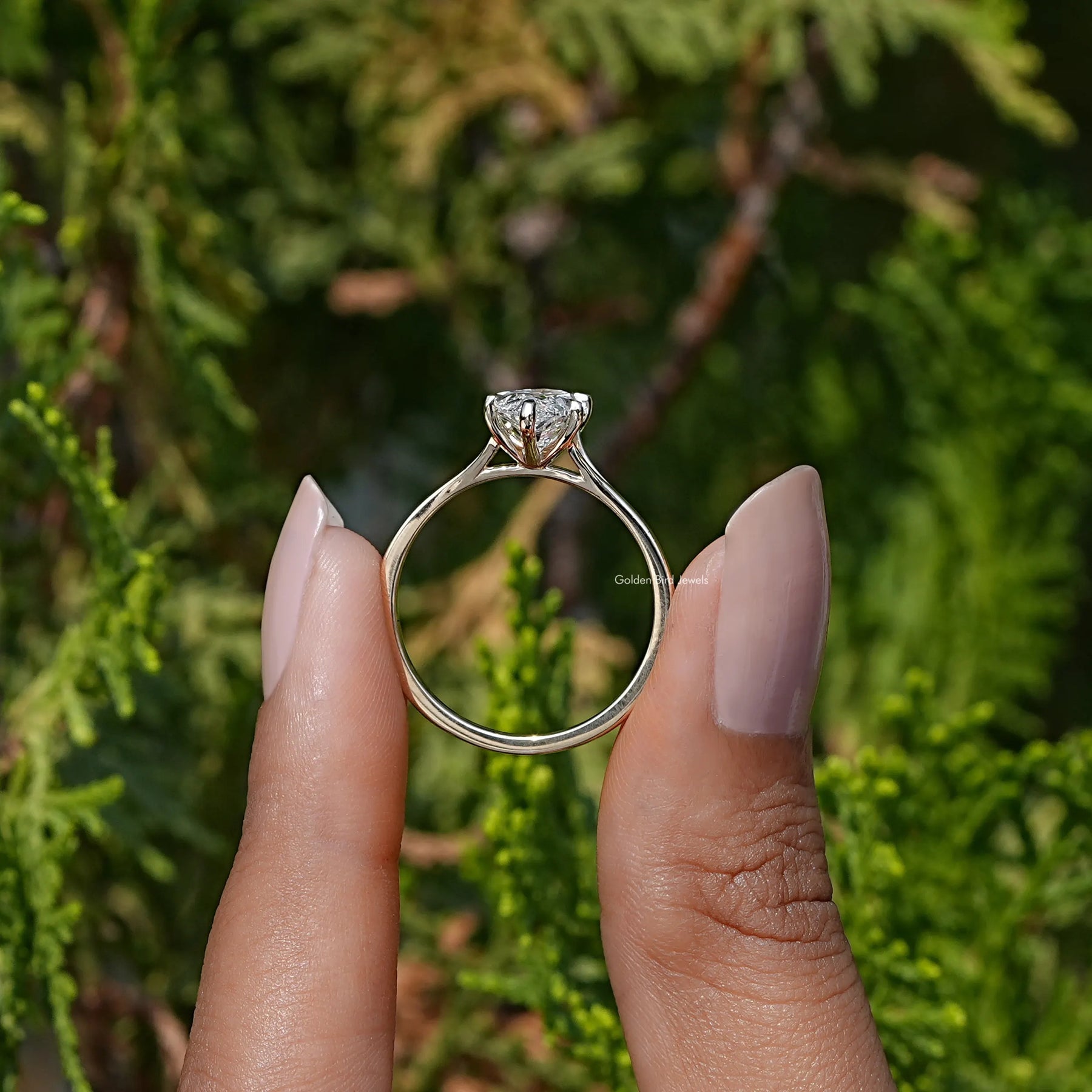 Back View of Marquise Cut Solitaire Engagement Ring In two fingers