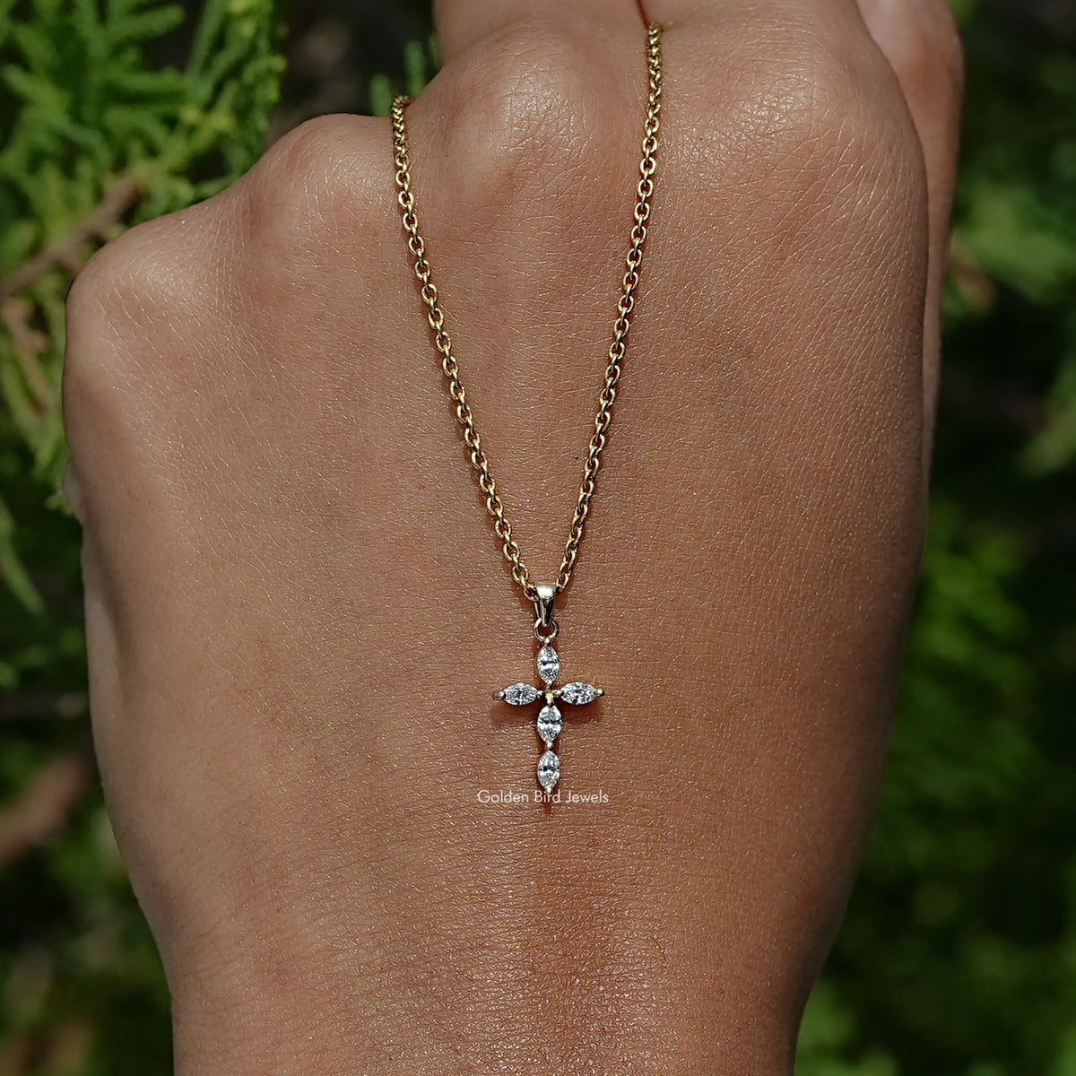 In Hand Holding the Marquise Lab Diamond Cross Pendant