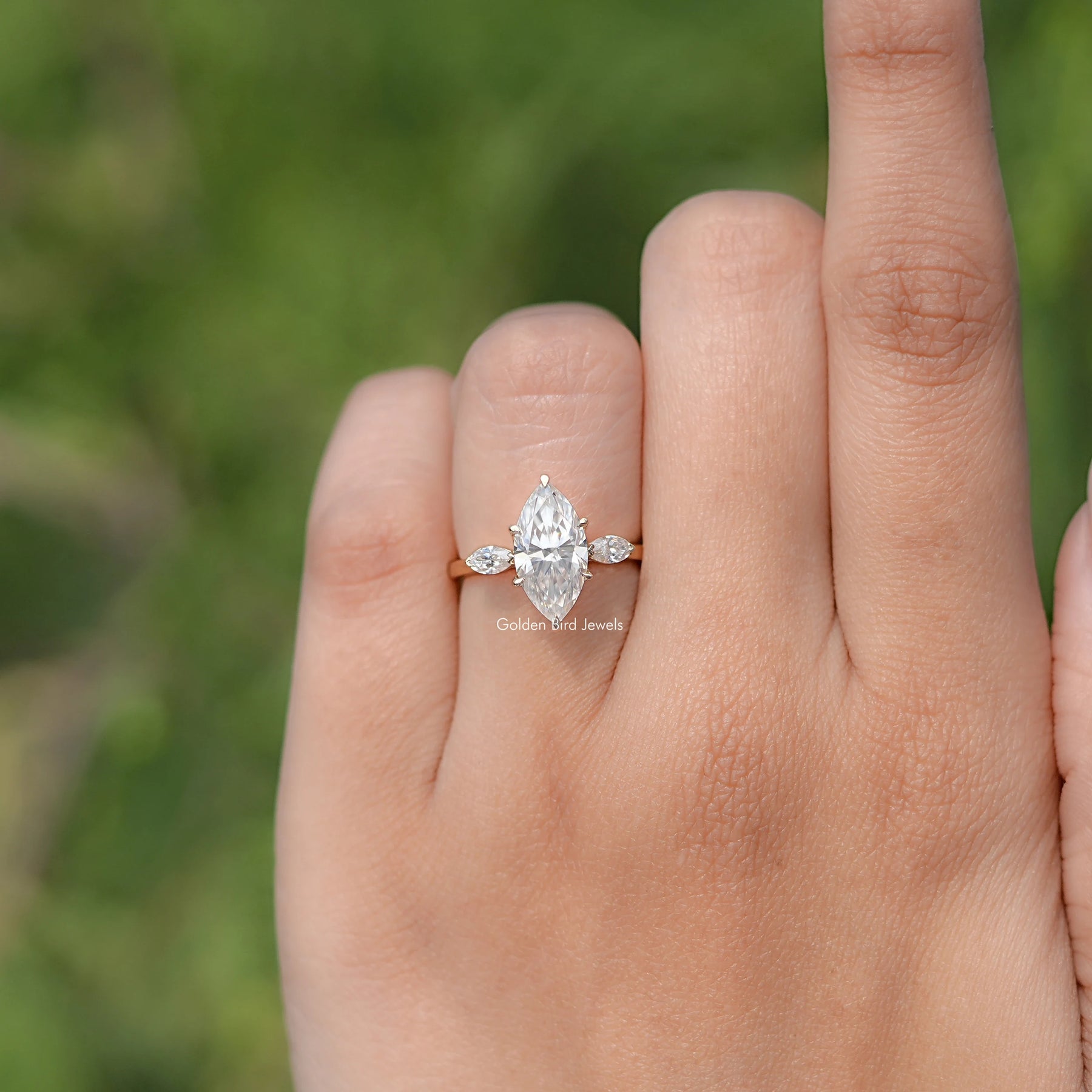 In finger front view of Marquise Cut Moissanite Three Stone Ring