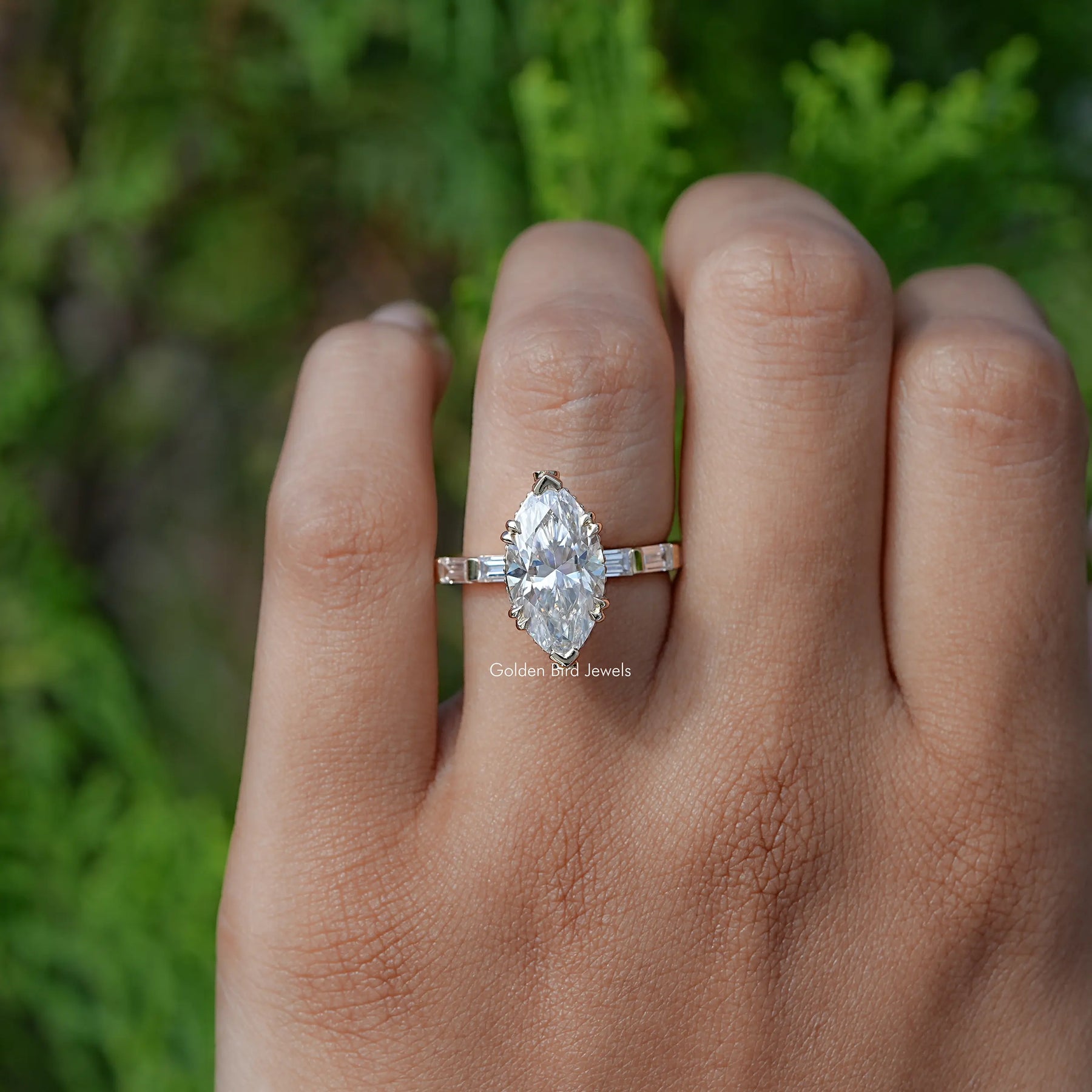 In finger front view of Marquise And Baguette Cut Moissanite Solitaire Accent Ring