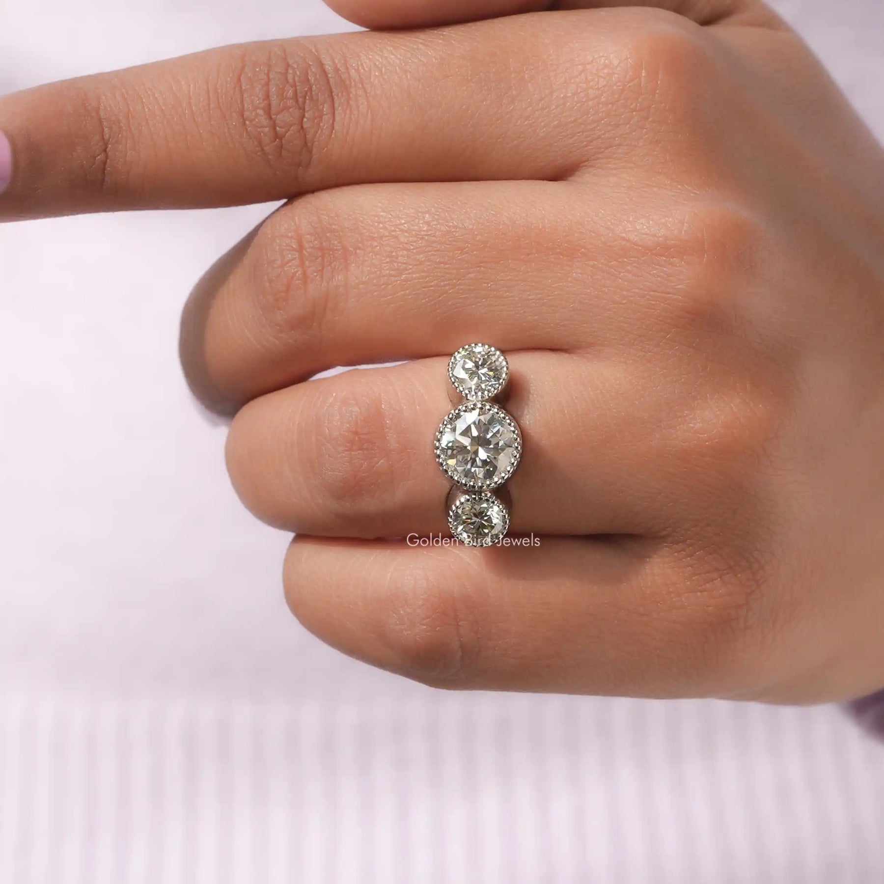View of Round Cut Bezel Set Moissanite Ring In finger
