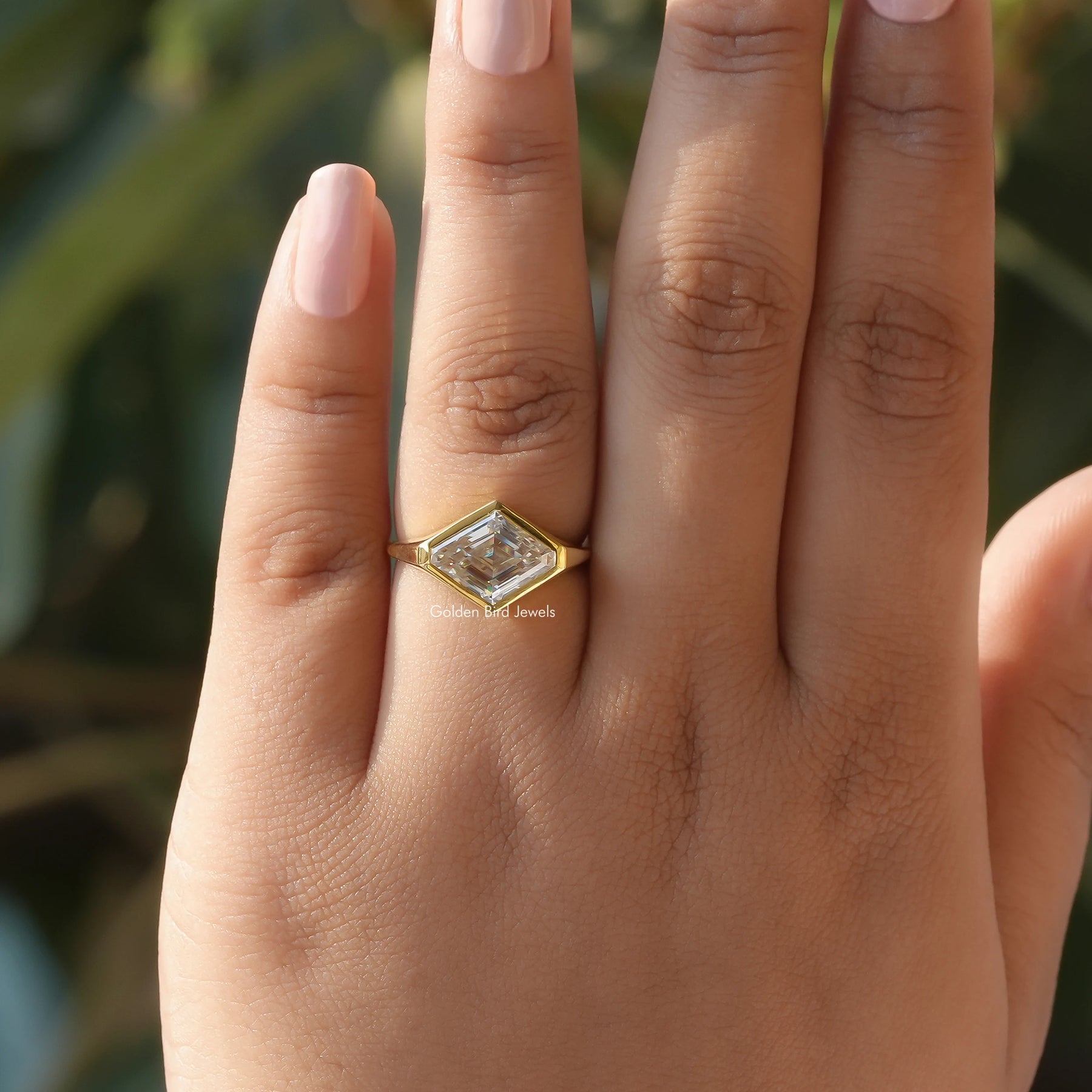 Bezel Set Modified Lozenge Cut Moissanite Solitaire Ring In finger