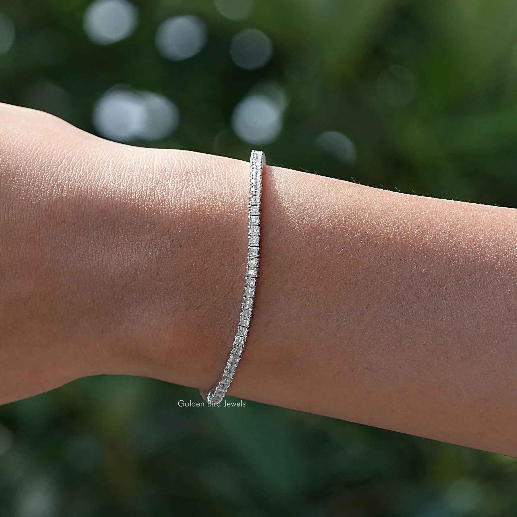 Top view of moissanite tennis bracelet in secure setting