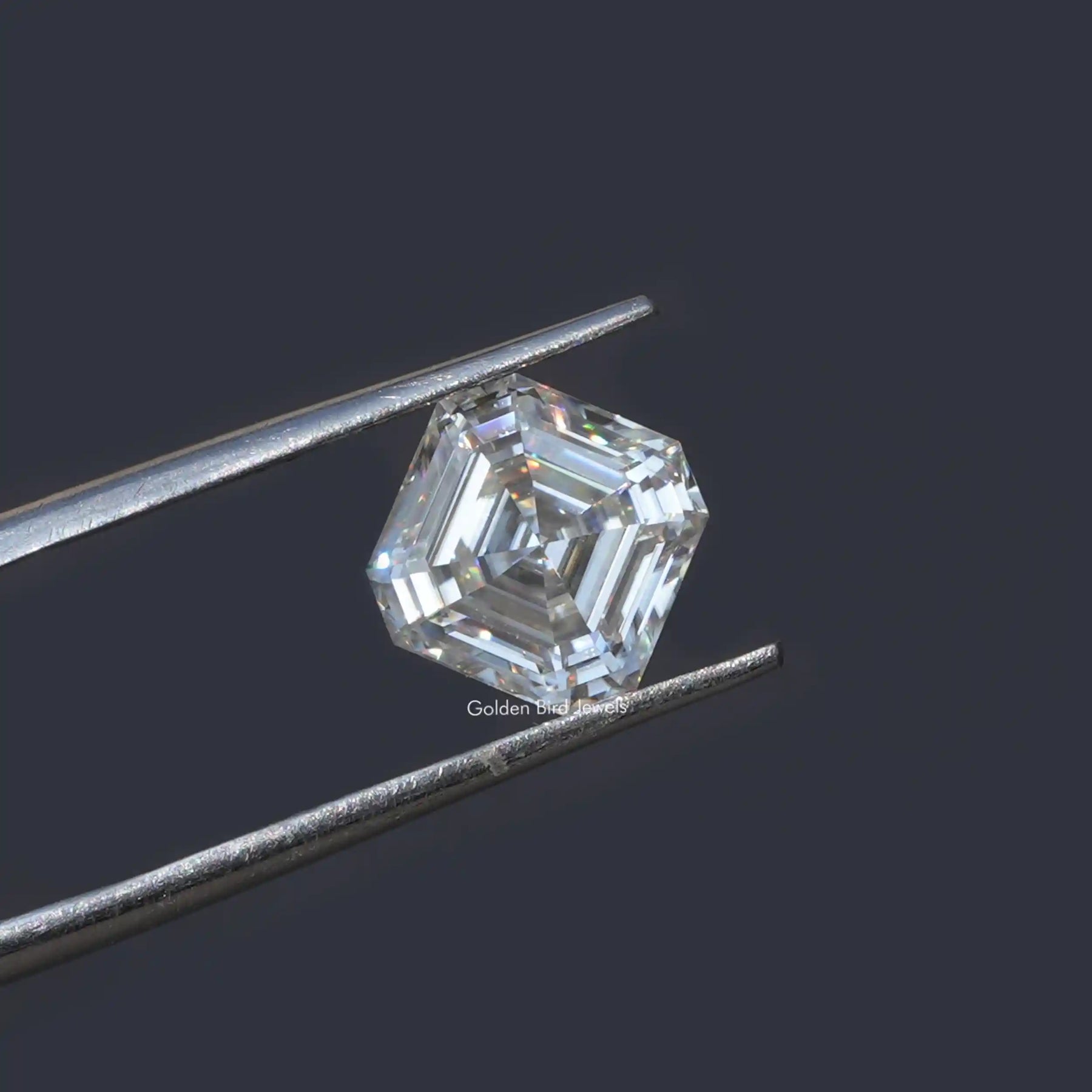 Tweezer holding the Colorless Asscher Cut Loose Moissanite